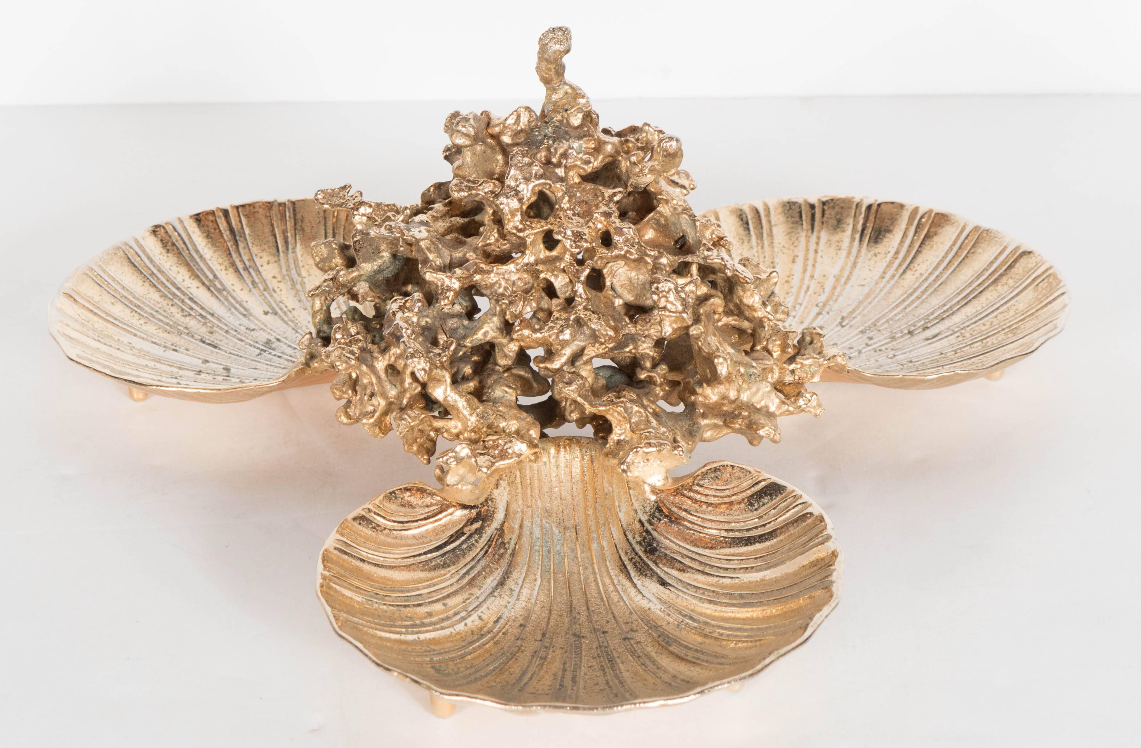 A stunning bronze dish set in 24-karat gilt finish signed by Claude Victor Boeltz. An organic sculptural center supports three shells which can be used as dishes or catch-alls. This piece is from his 