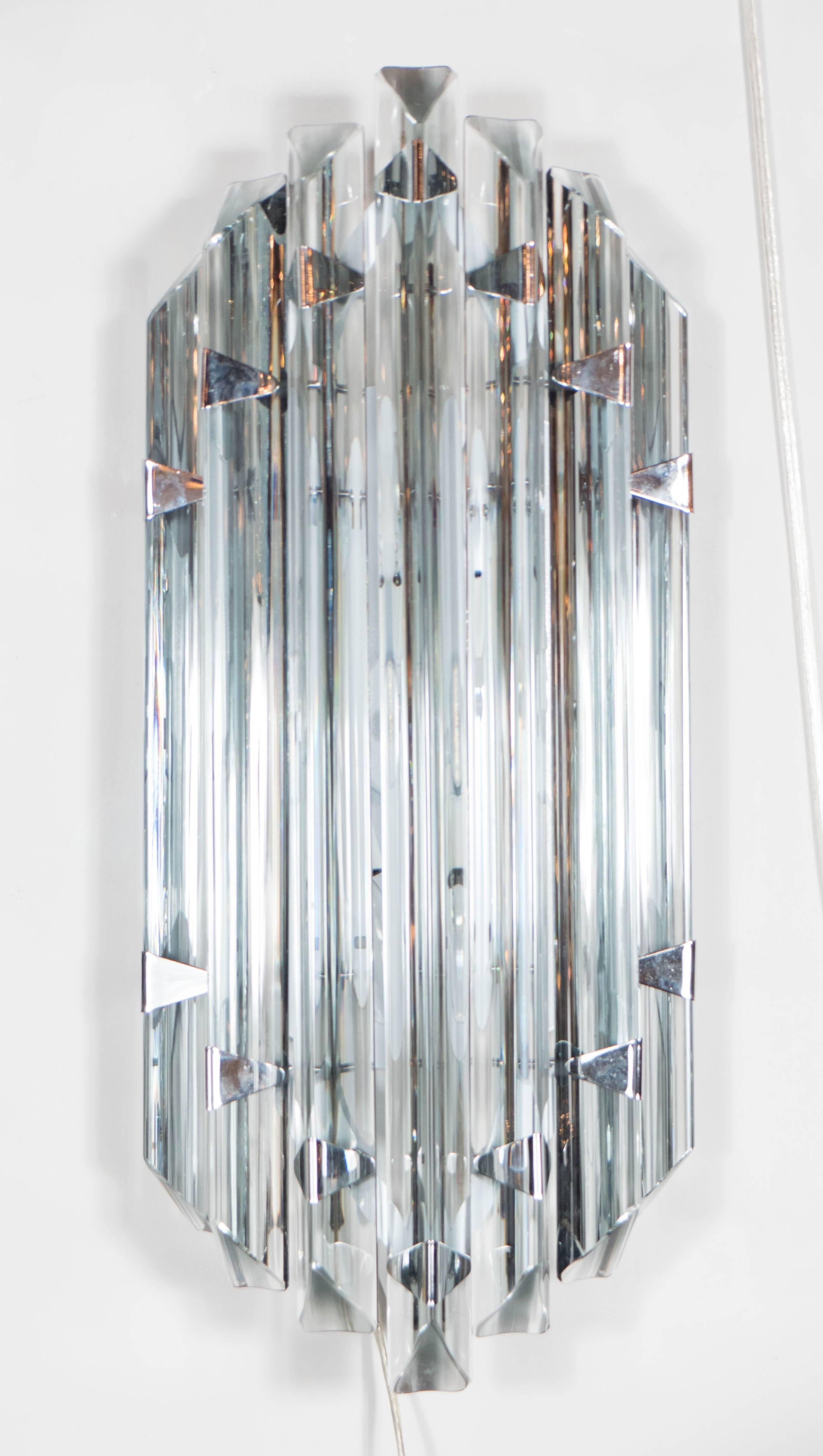 This elegant pair of modernist sconces, realized in the manner of Venini, were handblown in Murano- the island off the coast of Venice renowned for centuries for its superlative glass production. They feature a smoked Murano triedre rods attached to