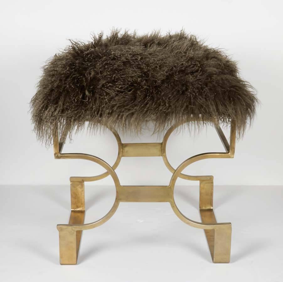 Chic Regency style bench with bronze coated wrought iron base and Mongolian lamb fur hand dyed in hues of mossy brown and the occasional dark green. The bench, made of hand-forged iron, features a stylized chain design reminiscent of the Gucci horse