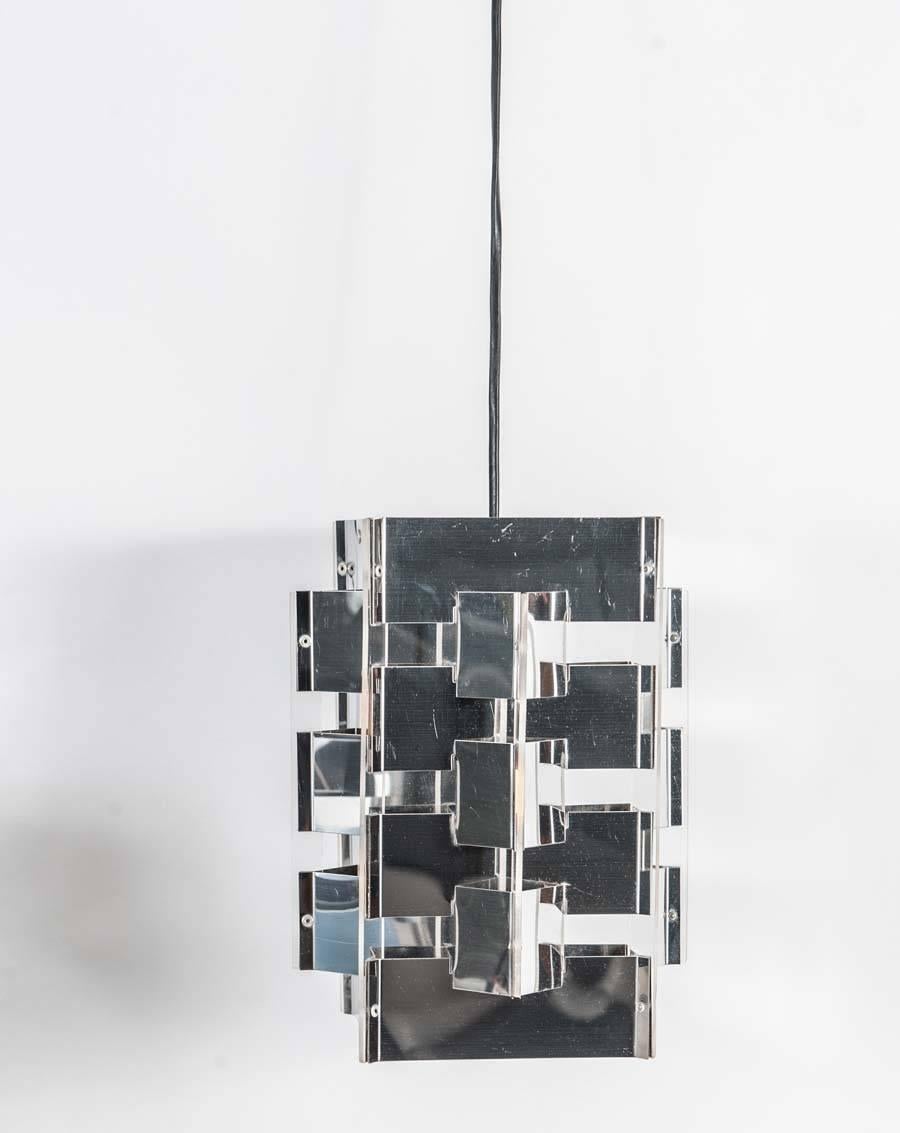 Set of two chrome and plexiglass hanging lamps designed in the 1950s by Dutch designer Jan Hoogervorst for Anvia Lighting Holland.
These lamps are usually made of strips of aluminum painted in two colors; however this rare set was made in