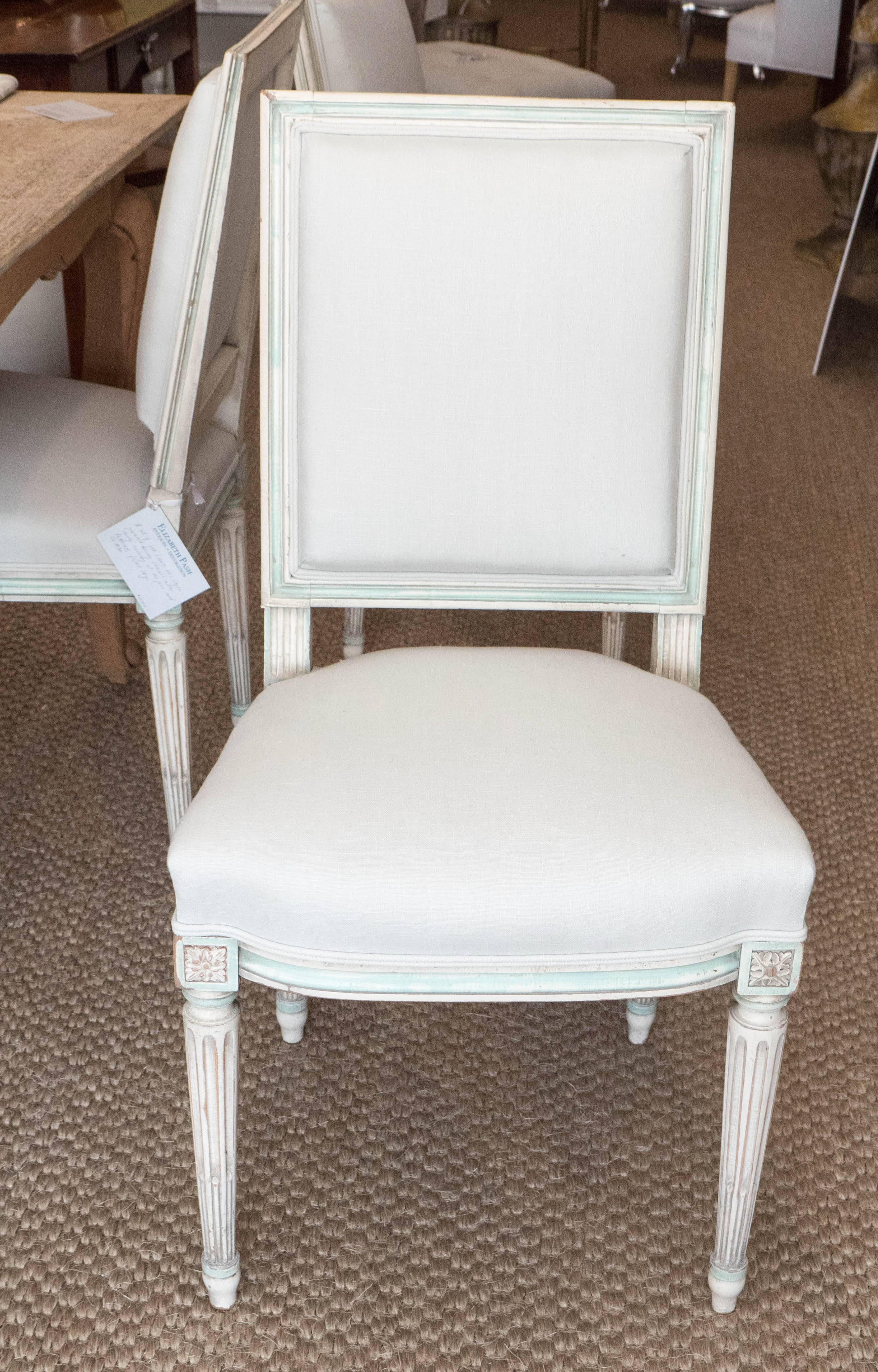 Timeless and elegant, these Louis XVI style chairs could feel at home in either contemporary or traditional surroundings. The back of the chair is squared, whereas the set is slightly curved, creating a gracious line. Painted in a grayish white,