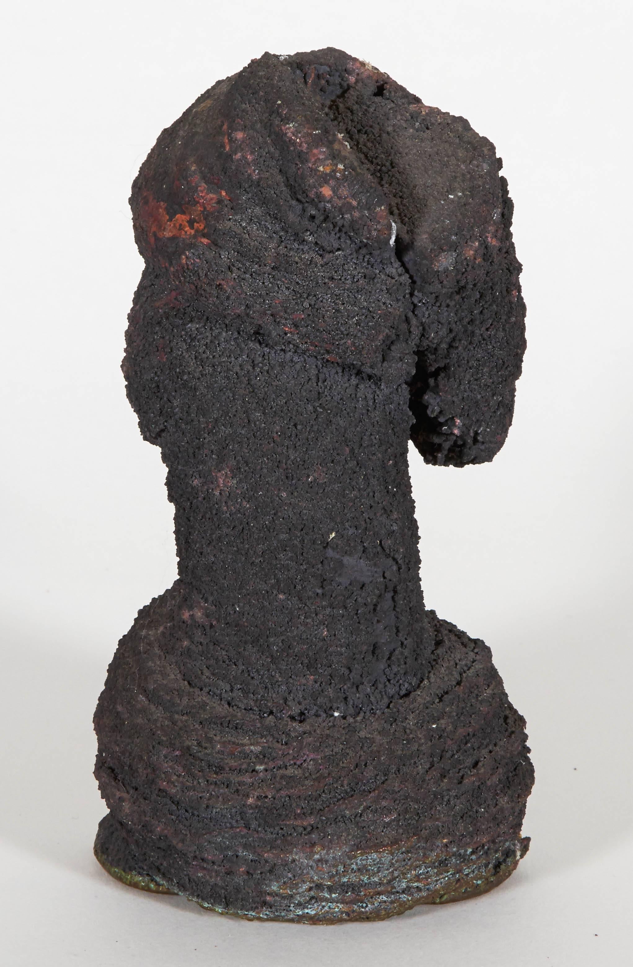 A unique example of Bertoia's pressure melt technique, wherein metals are heated and subjected to hammer blows to achieve the desired form. This piece is in bronze with a heavy coat of thick carbon material adhered to the surface.