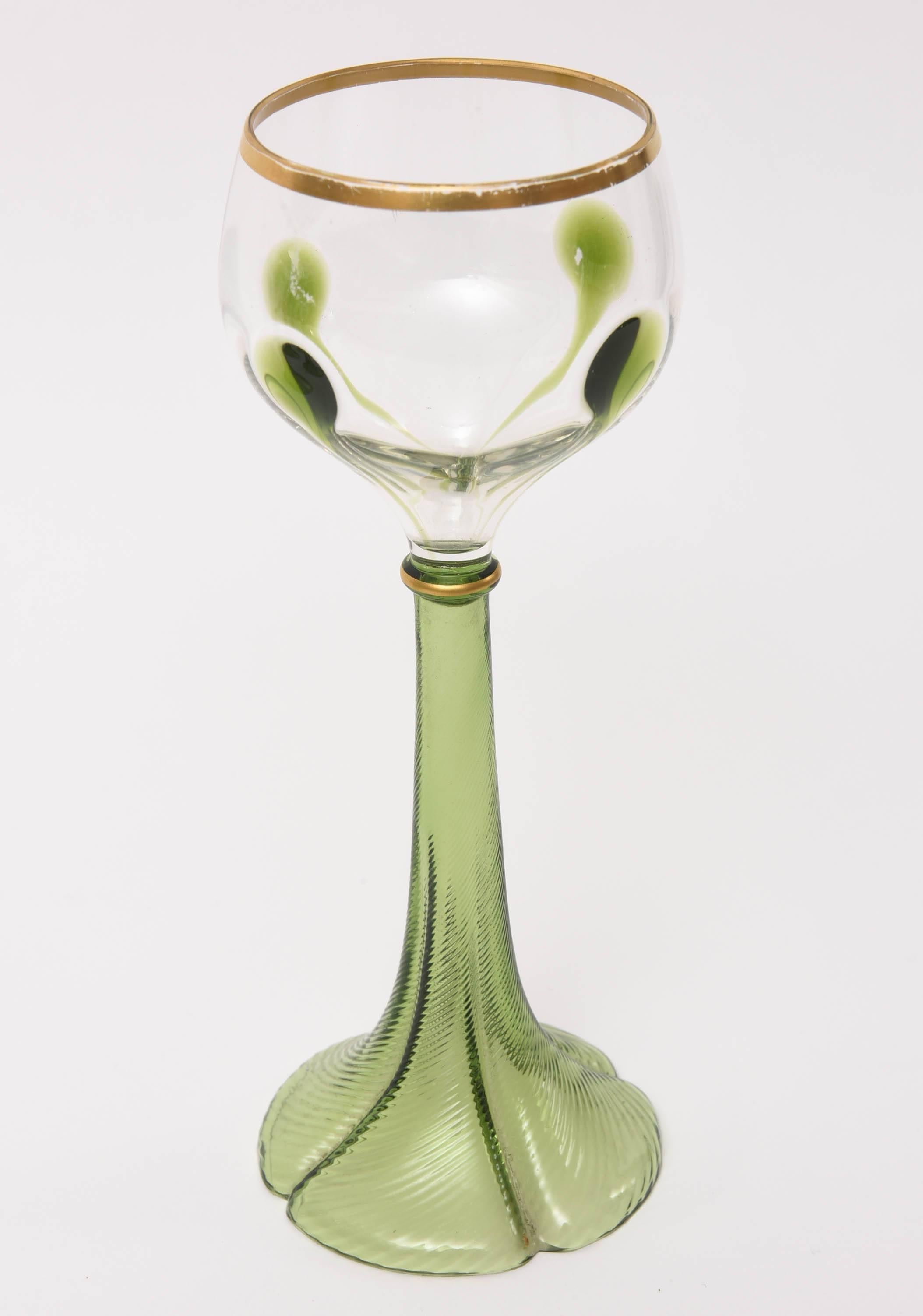 An elegant set of six blown wine goblets with extra applied green design to its bowl. Elaborately shaped stems with hand gilded rims and a well-proportioned overall glass. A classic art nouveau look with the teeniest of wear. Ready to mix and match