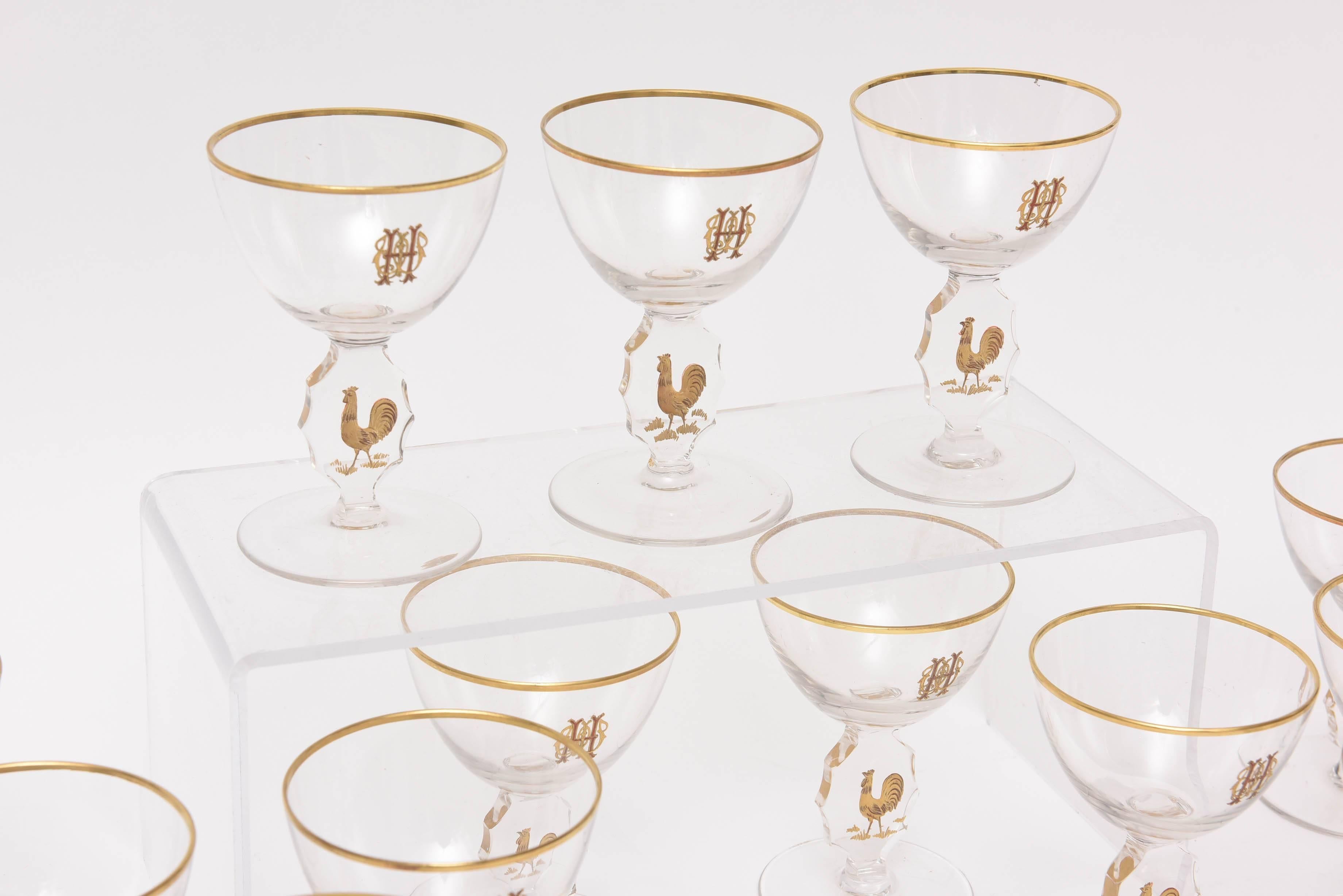 A whimsical yet elegant set of barware featuring 24-karat gold trim and elaborate monogramming. A cut and hand gilt rooster is featured on its unique cut stem. Attributed to one of the better French factories of Baccarat or Saint Louis. Ready to mix