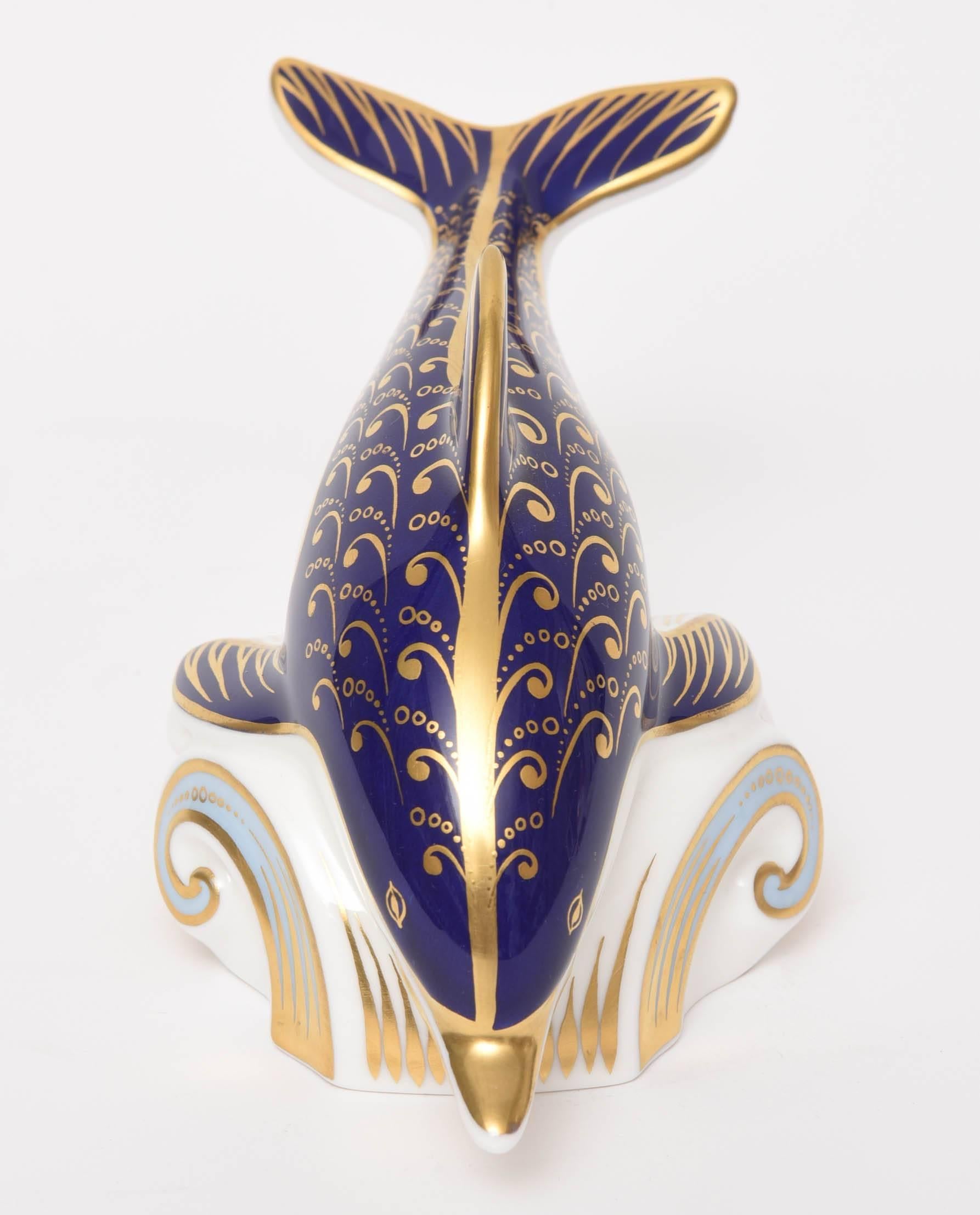 A whimsical and delightful dolphin shaped paperweight. Hand-painted double color blue and 24-karat gold. Such a treasure and measures just a little over 7.0