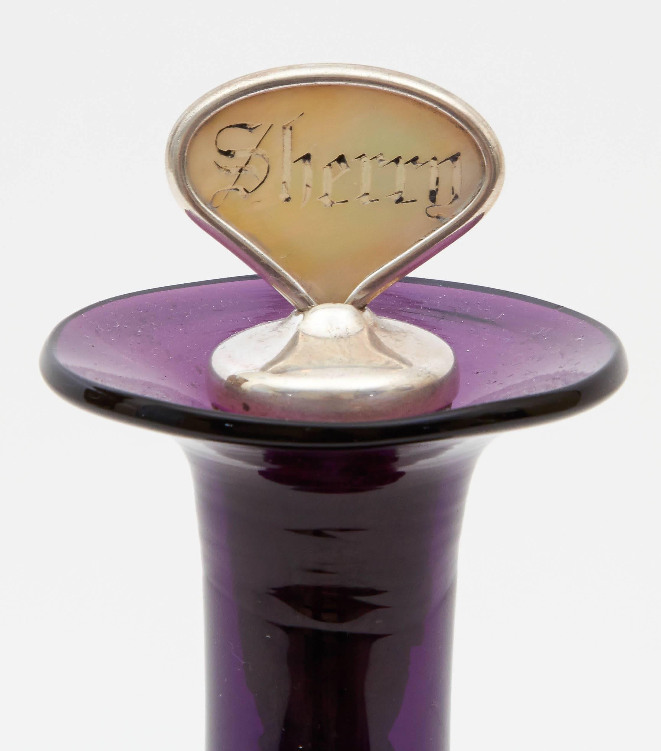 Antique English decanter from the 1860s. Regal purple glass brings elegance to any entertaining event. The decanter includes a Sherry sterling top.