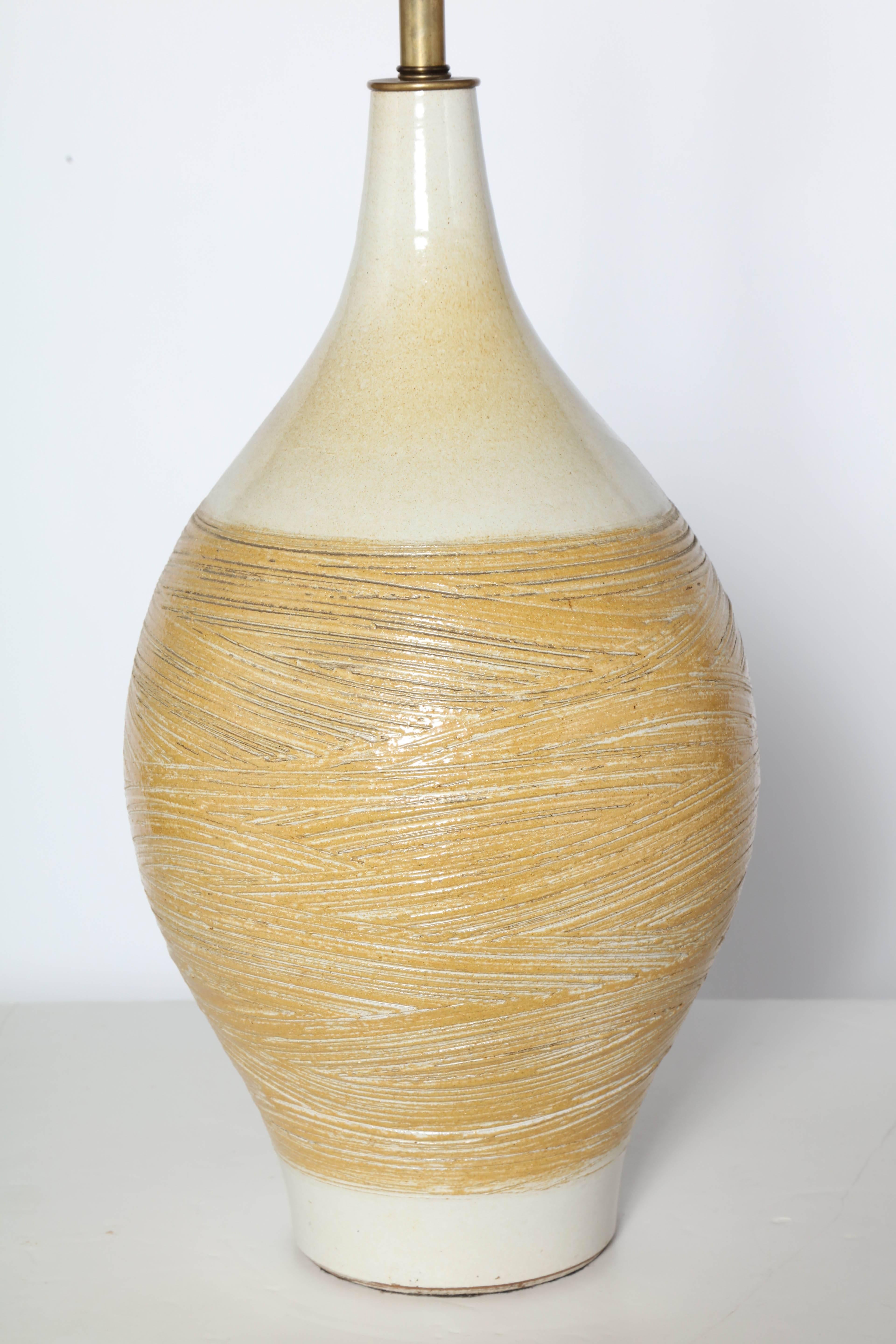 Monumental Lee Rosen for Design Technics Ball of Yarn Glazed Ceramic Table Lamp, 3300 Series. Featuring a handcrafted textured bulbous bottle form, Cream background with Mustard Yellow, Ochre and hand incised linear details. Lamp body 21H. Bright.