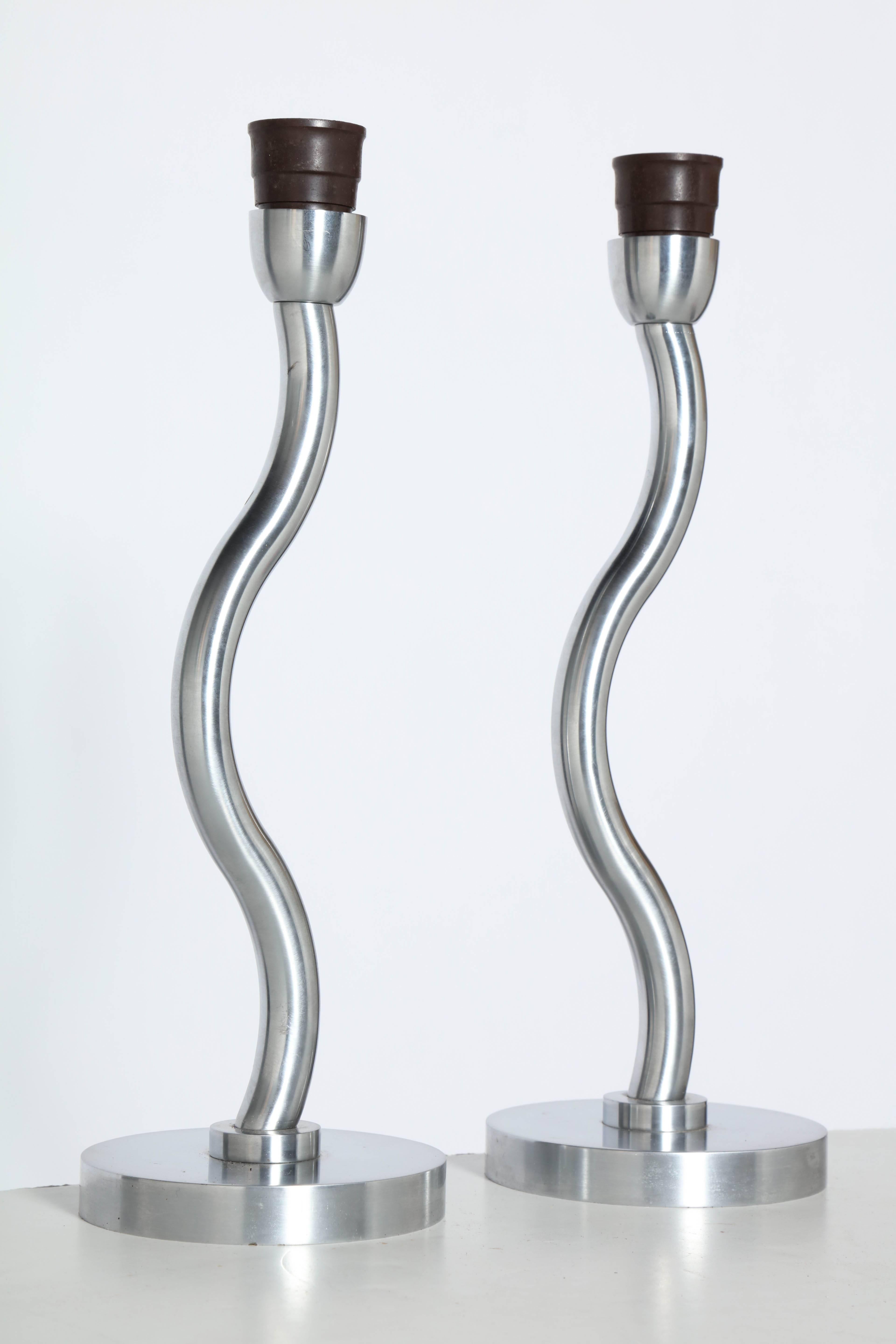 Pair Fine European Machined Brushed Steel Reading Desk Lamps, 1980's. Featuring a snake like design on round base. Heavy. Curvaceous. Sculptural. Handsome. Rarity. Small footprint. Entryway. Foyer. Mantel. Kitchen. Made in Europe. Rewired with Black
