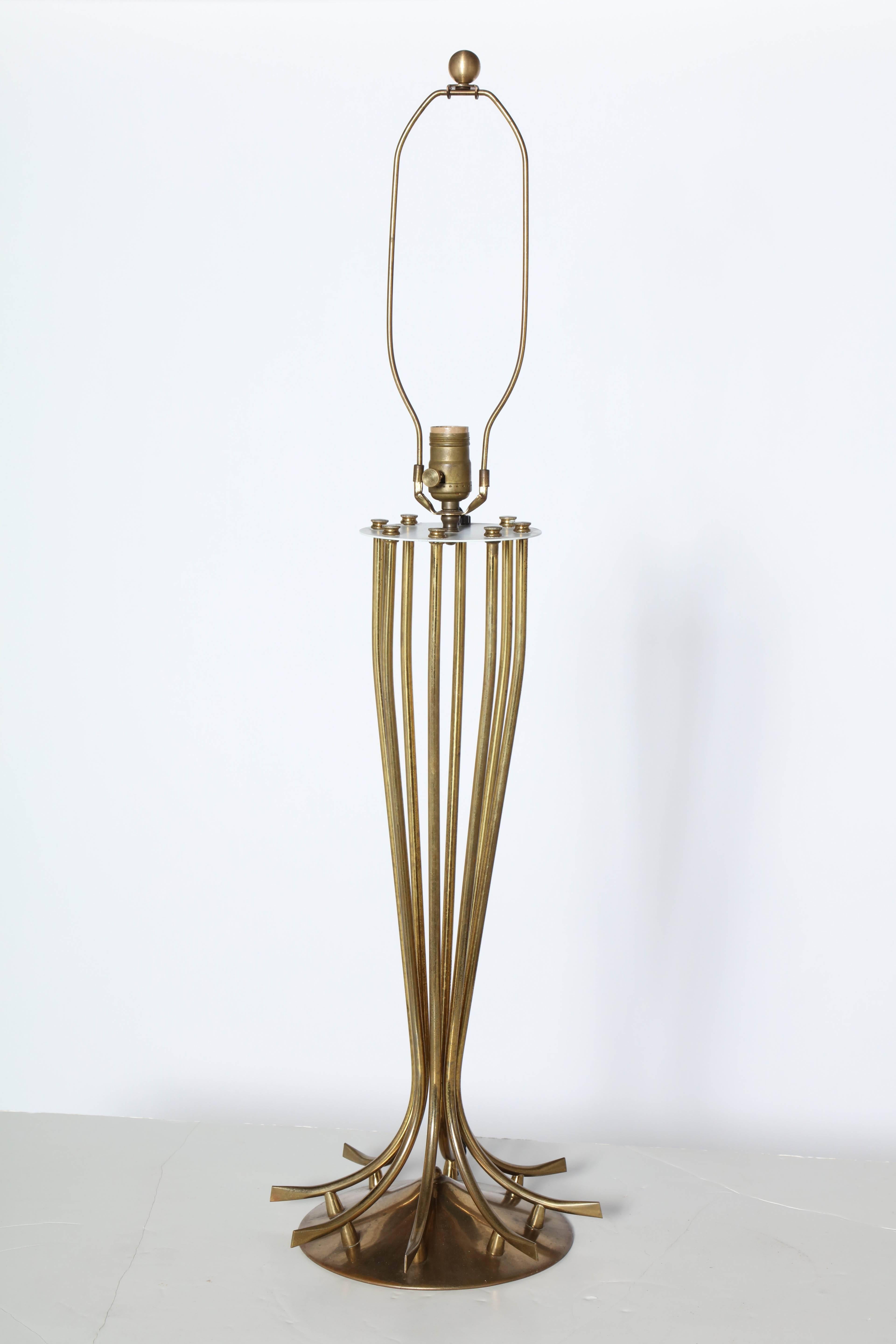 Substantial French Modern Brass Table Lamp. Featuring a low corseted form, eight Brass radiating spokes, elevated supports and round splayed base detailed with a White enameled metal cap. Sculptural. Lyrical. Statement lighting. 