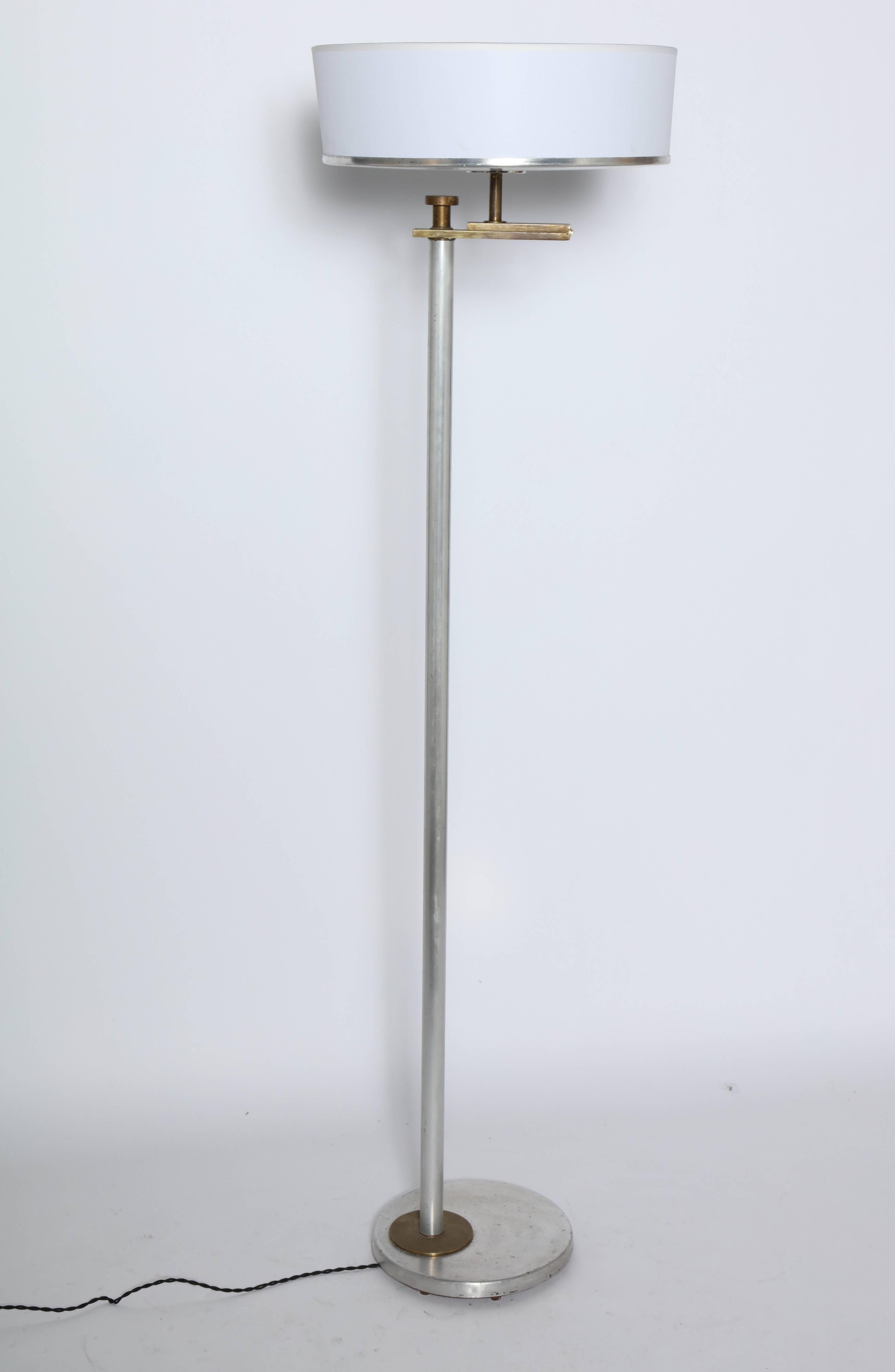 Modernist Kurt Versen Brushed Aluminum and Brass Flip Top Reading Floor Lamp. Featuring Brushed Aluminum column, cap and base, Brass arm and disc detail with new White Parchment Shade. Shade designed for use in upward or downward position.
