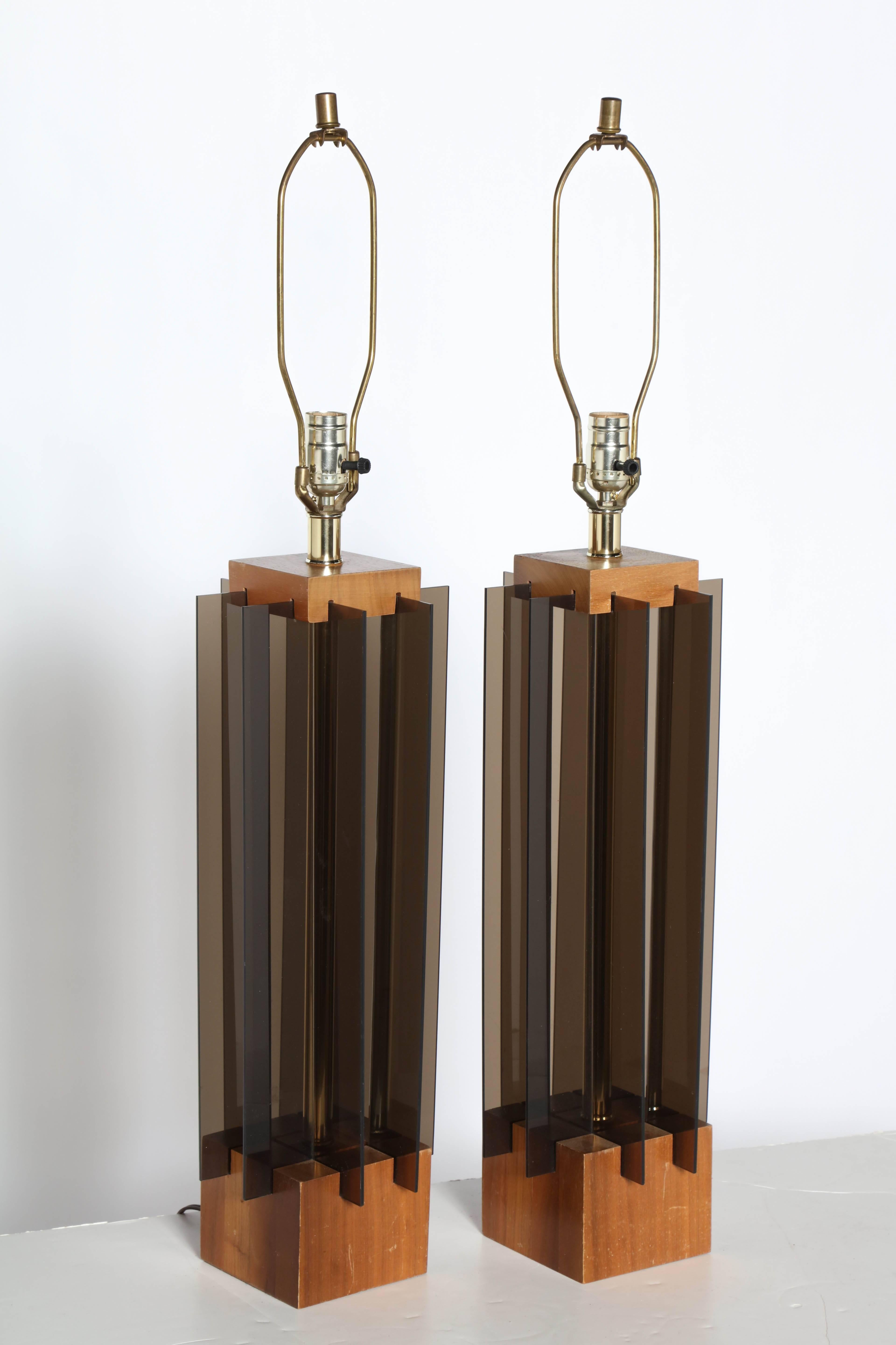 Substantial Pair of International Style Laurel Lamp Co. attributed Walnut, Lucite & Brass Table Lamps, 1960s. Featuring a Walnut rectilinear form, open center, tubular Brass central column, and eight Gray translucent Acrylic panels per lamp on a (5