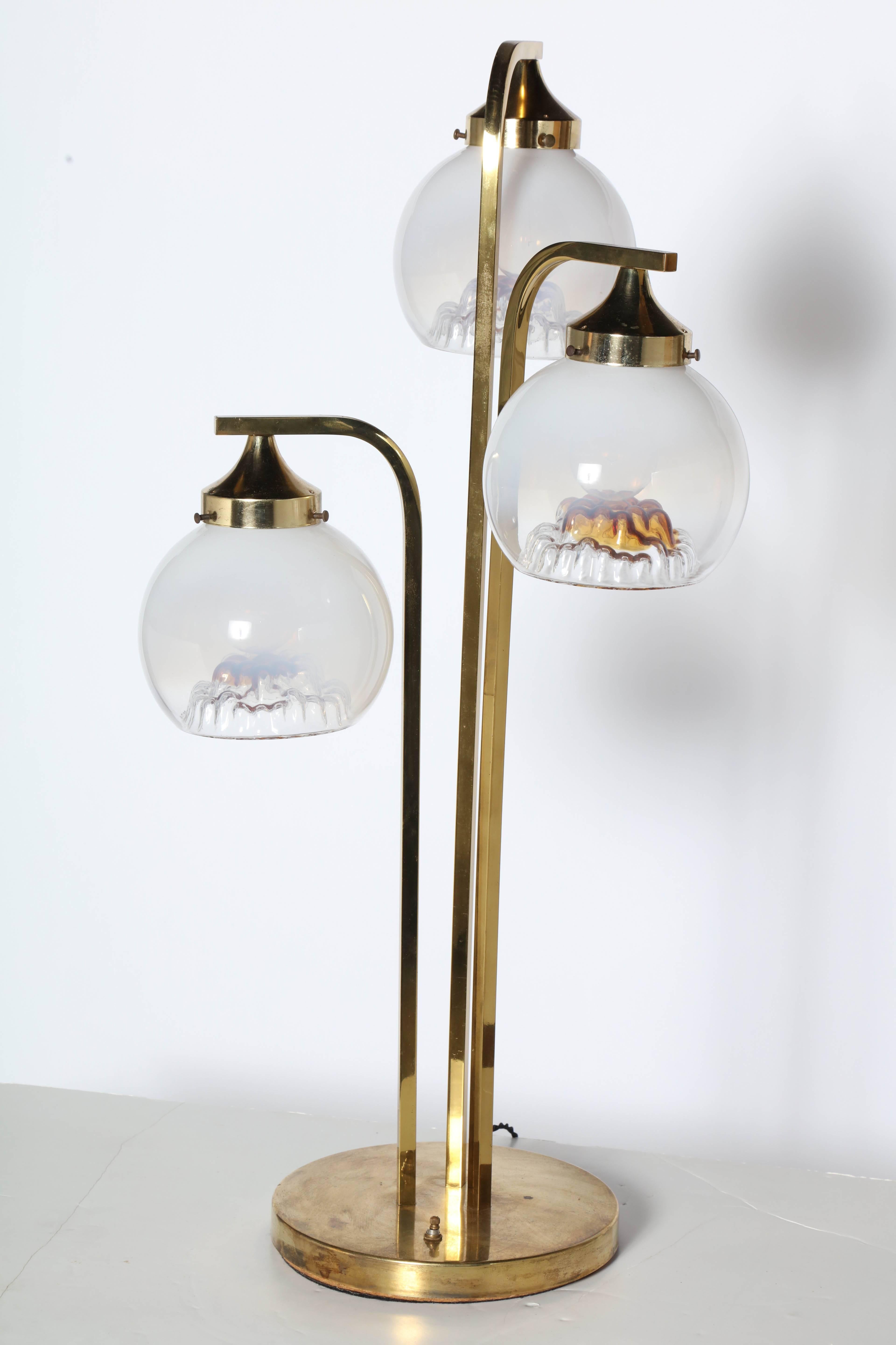 Tall Italian Modern A. V. Mazzega Venetian Murano Glass & Brass Table Lamp. Featuring three curved Brass waterfall columns and three botanically inspired hand blown Murano White Frosted  Amber tinted Art Glass Globes on a lightly patinated round 10