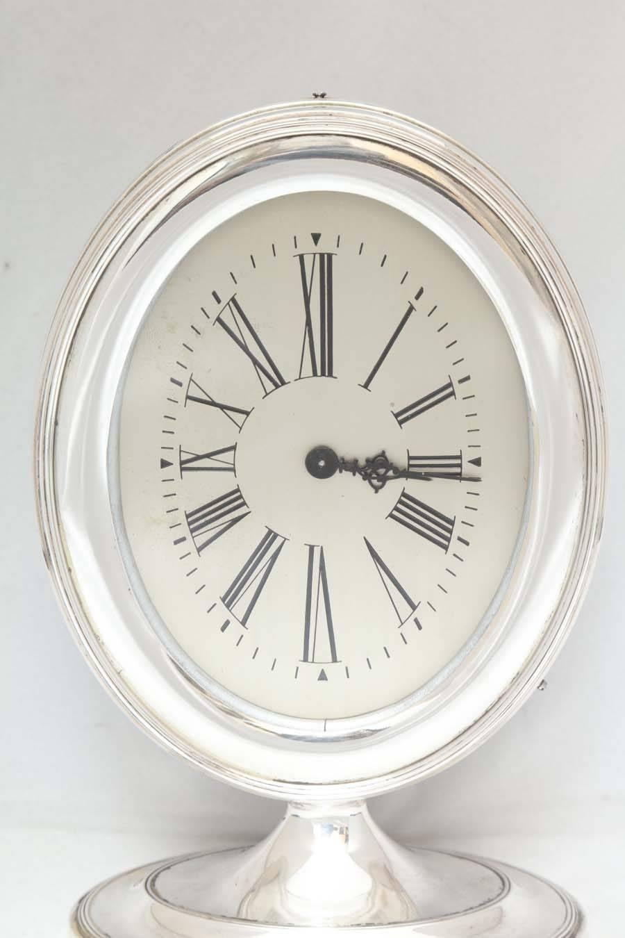 Beautiful, Art Deco, sterling silver table clock, Reed & Barton, Taunton, Mass., circa 1920s-1930s. Wood back. Measures: 8 3/4