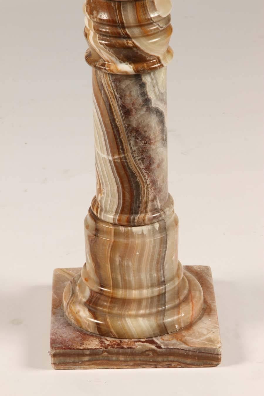 Marble column with simply magnificent striations in brown, gold, and cream. This would be a fantastic support for an urn, bust or vase filled with a fresh arrangement of flowers.