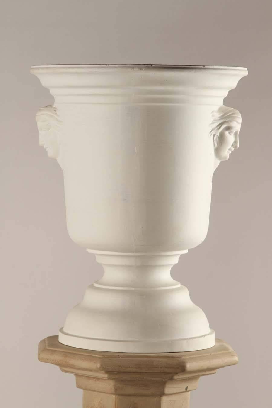 This is a pair of light fixtures in the form of urns set atop columns. Plaster urns on wood columns.
Standard sockets.