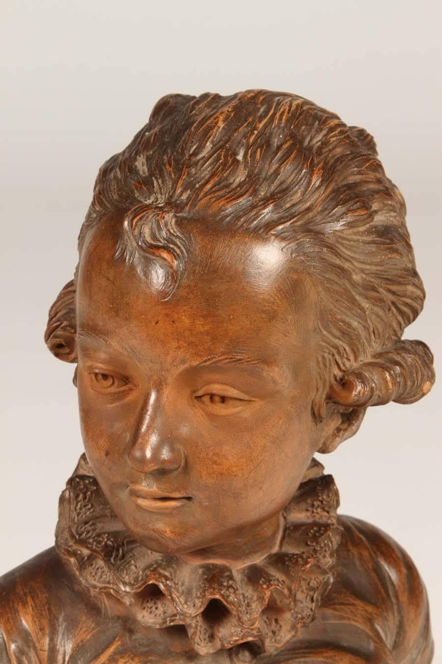 This absolutely lovely terra cotta bust representing Mozart as a child is from the 19th century. It is in excellent condition for a piece of it's age. It sits upon a turned walnut base. This is truly a treasure!