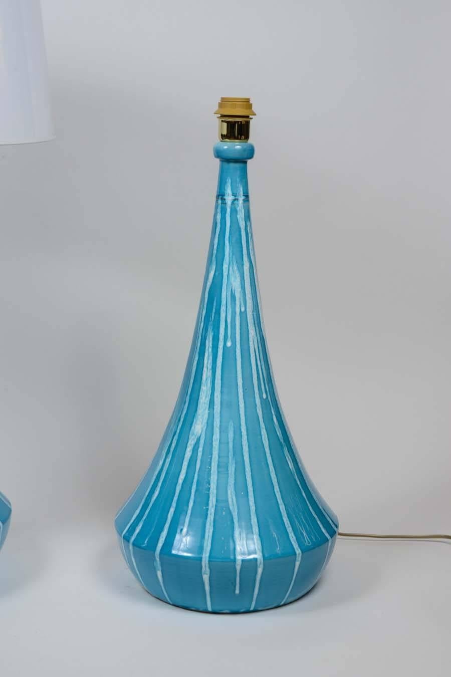 Pair of Italian lamps made of light blue glazed ceramic with white dripping and brass setting.

 