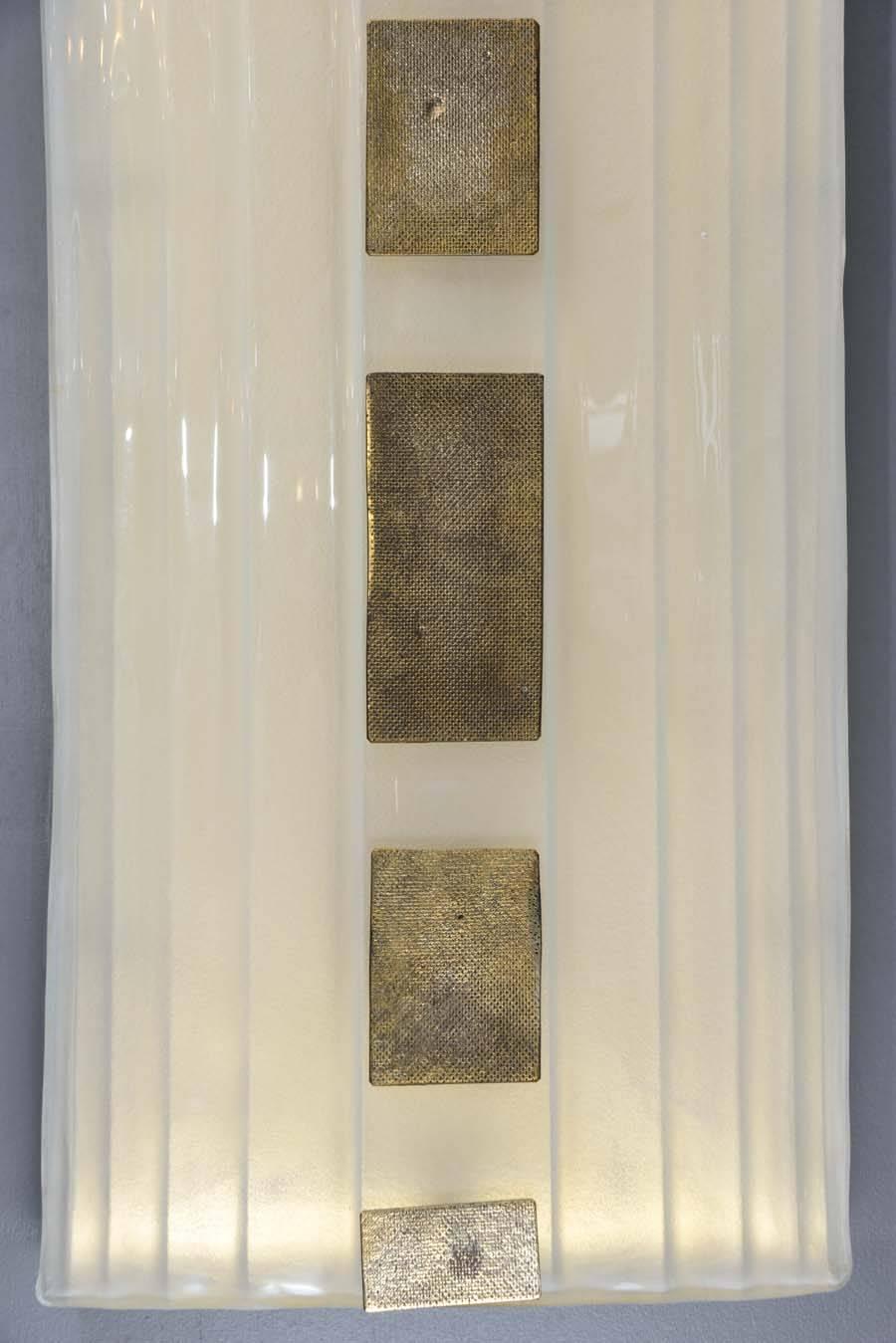Big set of ten wall sconces, made of frosted Murano glass with small patinated metal squares.