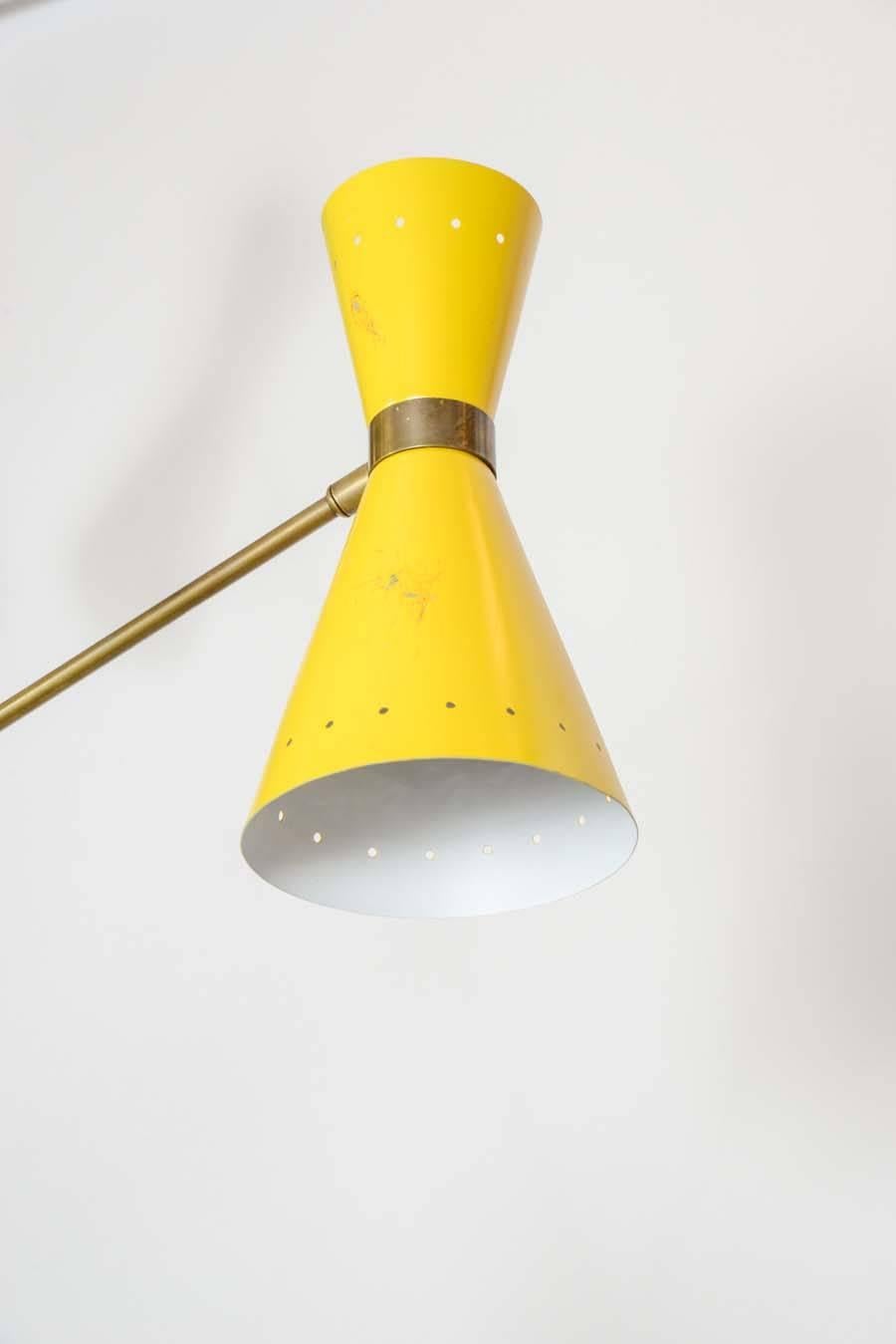 Decorative and colorful Stilnovo floor lamp made of brass body and enameled metal cones.
The arms as well as the cones can be rotated. 
Two lights per arm.