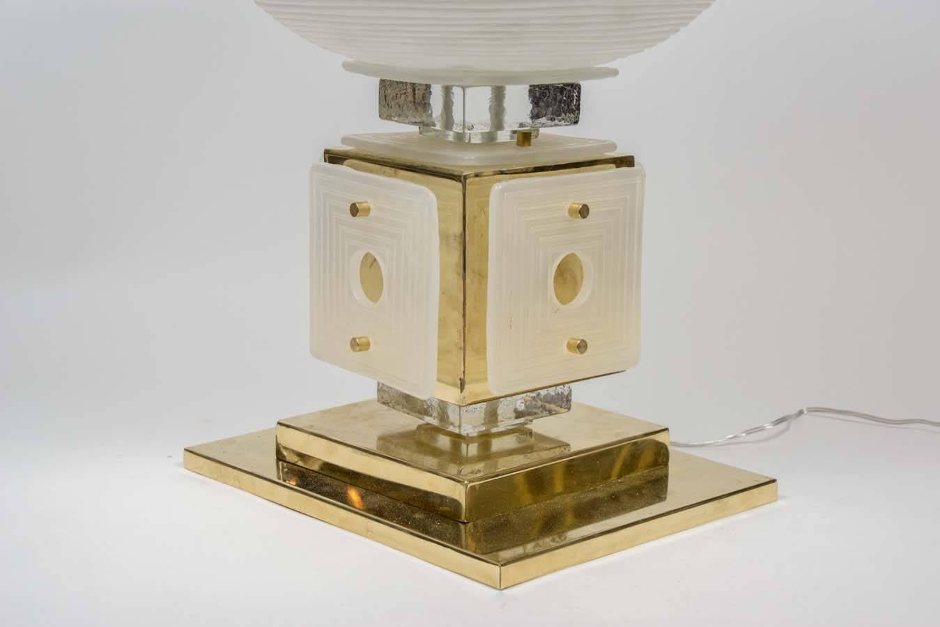 Impressively big table lamp made of brass foot, clear Murano glass and white glass panels; everything topped by a big textured white glass globe.

One lamp available
