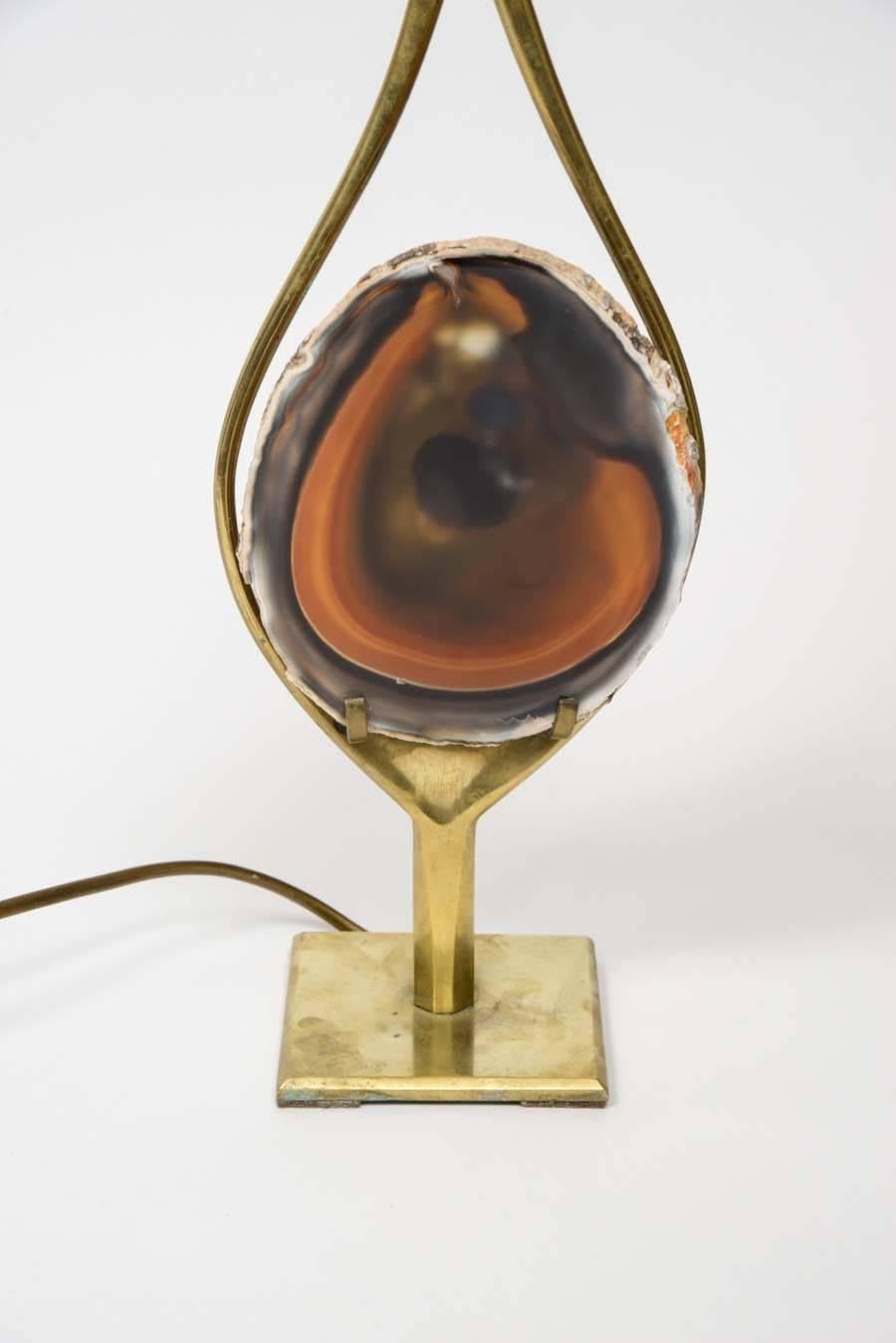 Nice lamp by Willy Rizzo made of a brass structure and a slice of agate stone.

The shape of the lamp and the deep orange and brown color of the stone show the artist's desire to create a lamp representing a flame.