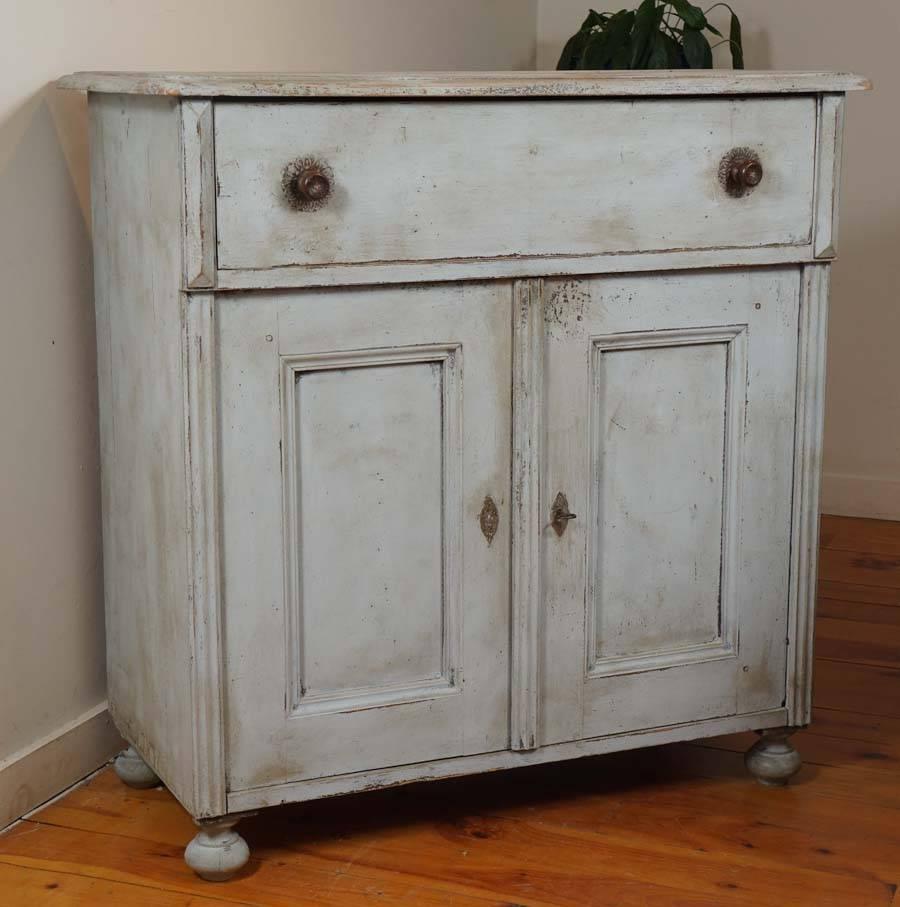 What a sweet, sweet piece this is. The hardware is original and it’s the knobs on the large drawer that your eye will be attracted to. The soft blue/grey paint is wonderful and with one original shelf inside, this French buffet is as nice a small