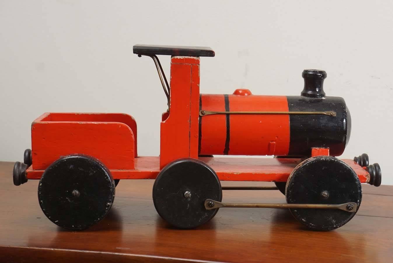 This is a small part of a larger collection at Painted Porch of handmade wooden toy trains. We love children's toys as an accessory in a country home. This one it totally original with some metal parts and original wheels in red and black. Its a