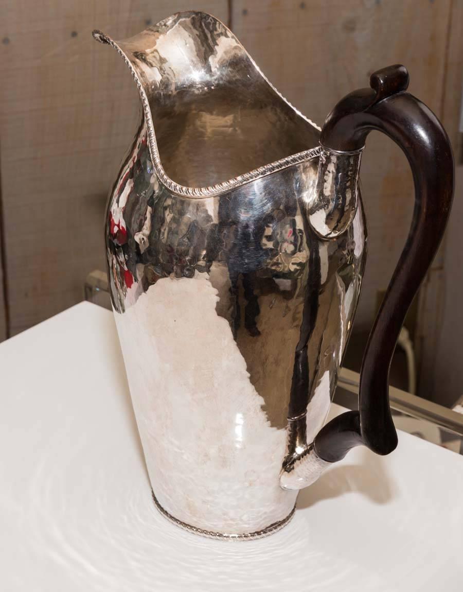 Tall hammered silver pitcher.