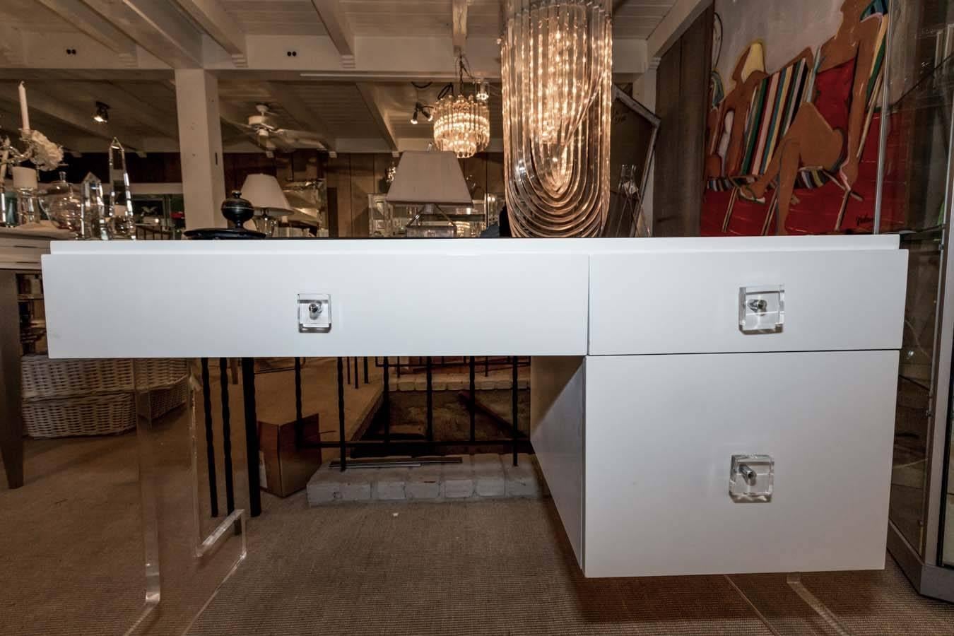 Very attractive and unusual white lacquer desk with cut-out Lucite sides and Lucite drawer pulls.
