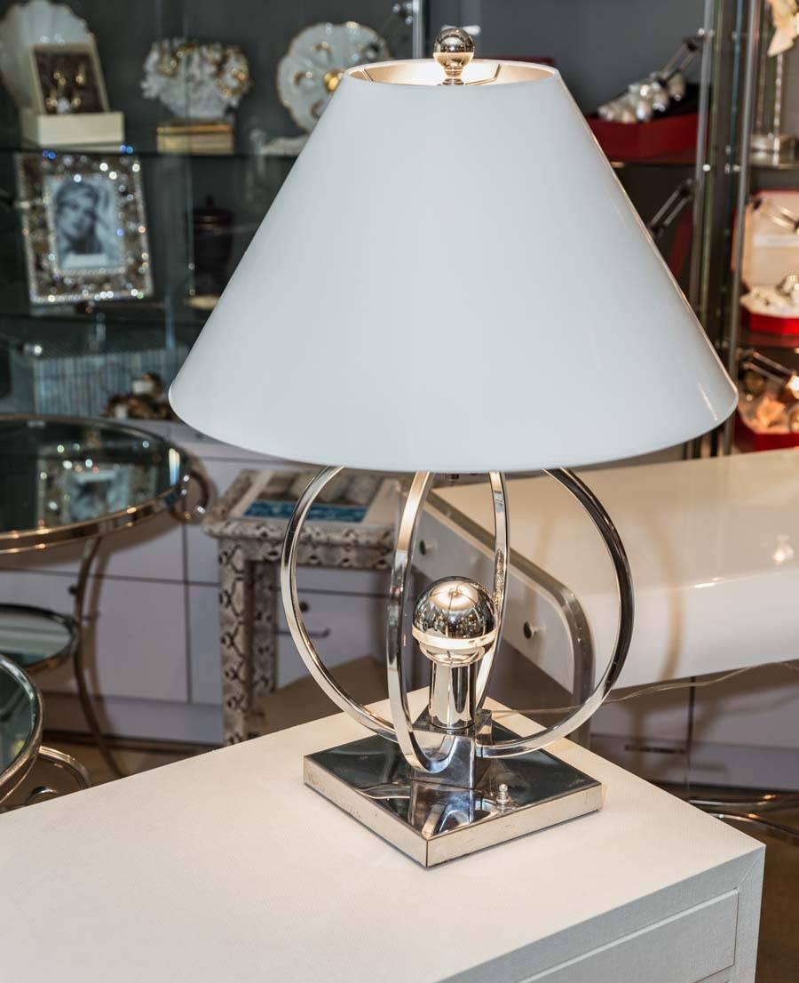 Unusual chrome spherical table lamp with custom shade. The light has three different positions. The lamp was newly rewired.