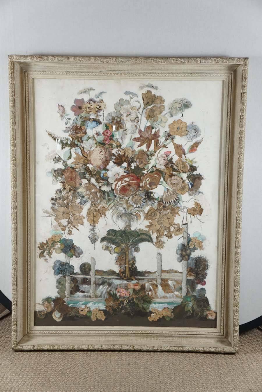 Here is a beautiful collage painting of a large bouquet of flowers. The painting has some surrealist elements as it consists of a natural scene of a waterfall and palm trees and columns integrated as a landscape with the large bouquet. The details