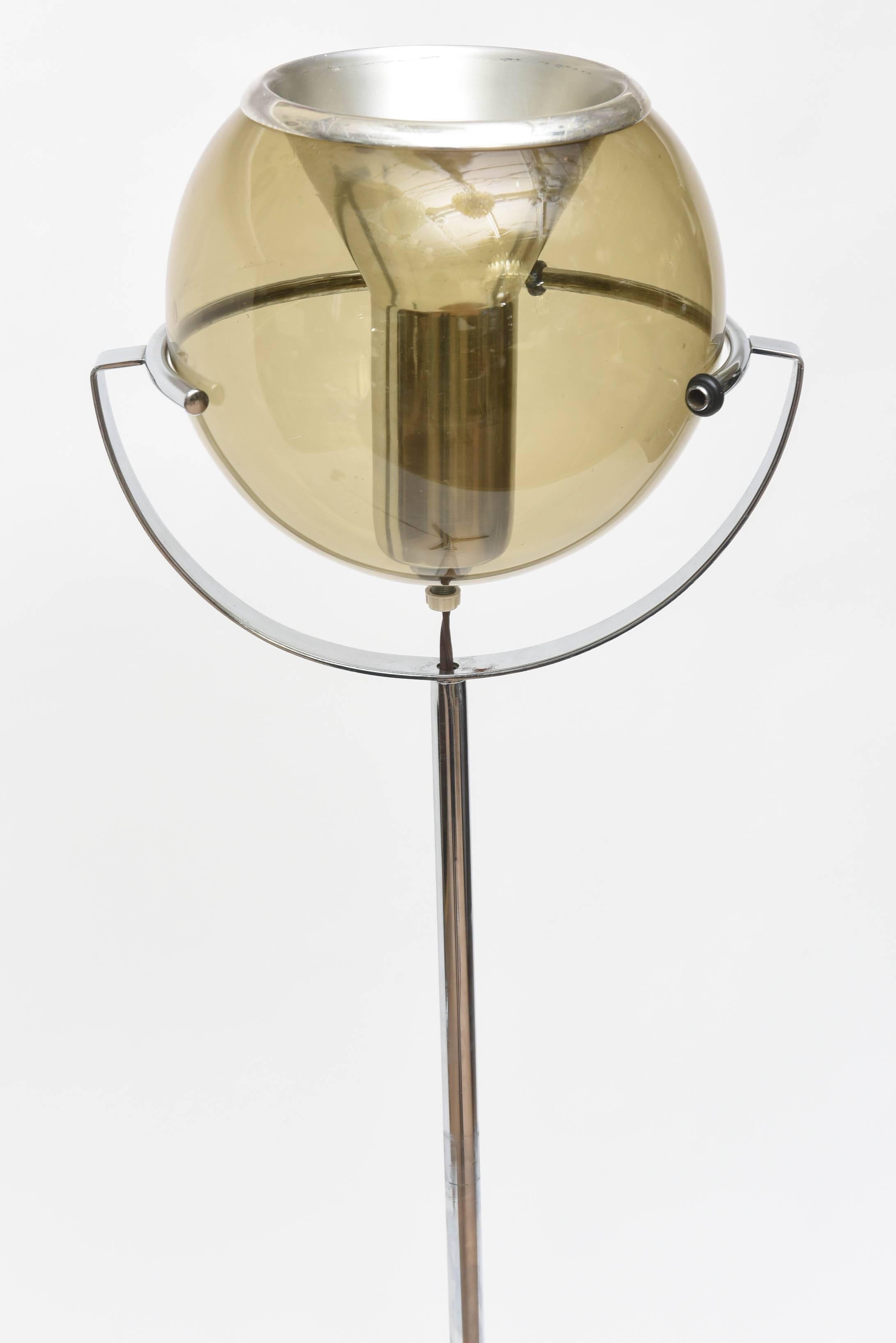 Aluminum floor lamp with adjustable smoked glass globe which is centered by the light source. Max Wattage is 100W.