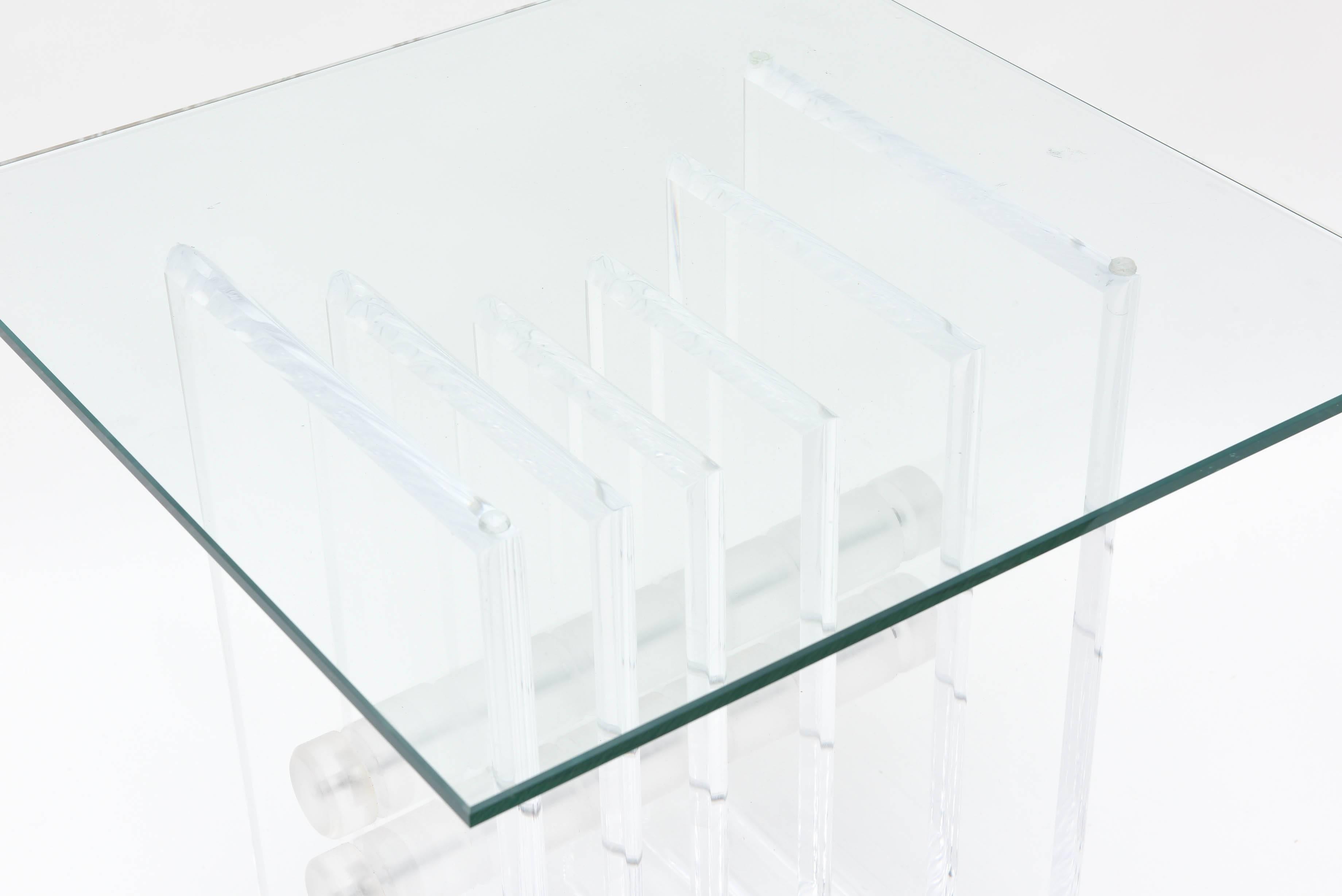 Mid-Century Modern Lucite and Glass End, Side or Drink Table consisting of heavy Lucite plates vertically arranged and held together by two cylindrical Lucite rods.
Rectangle Glass Top included.
