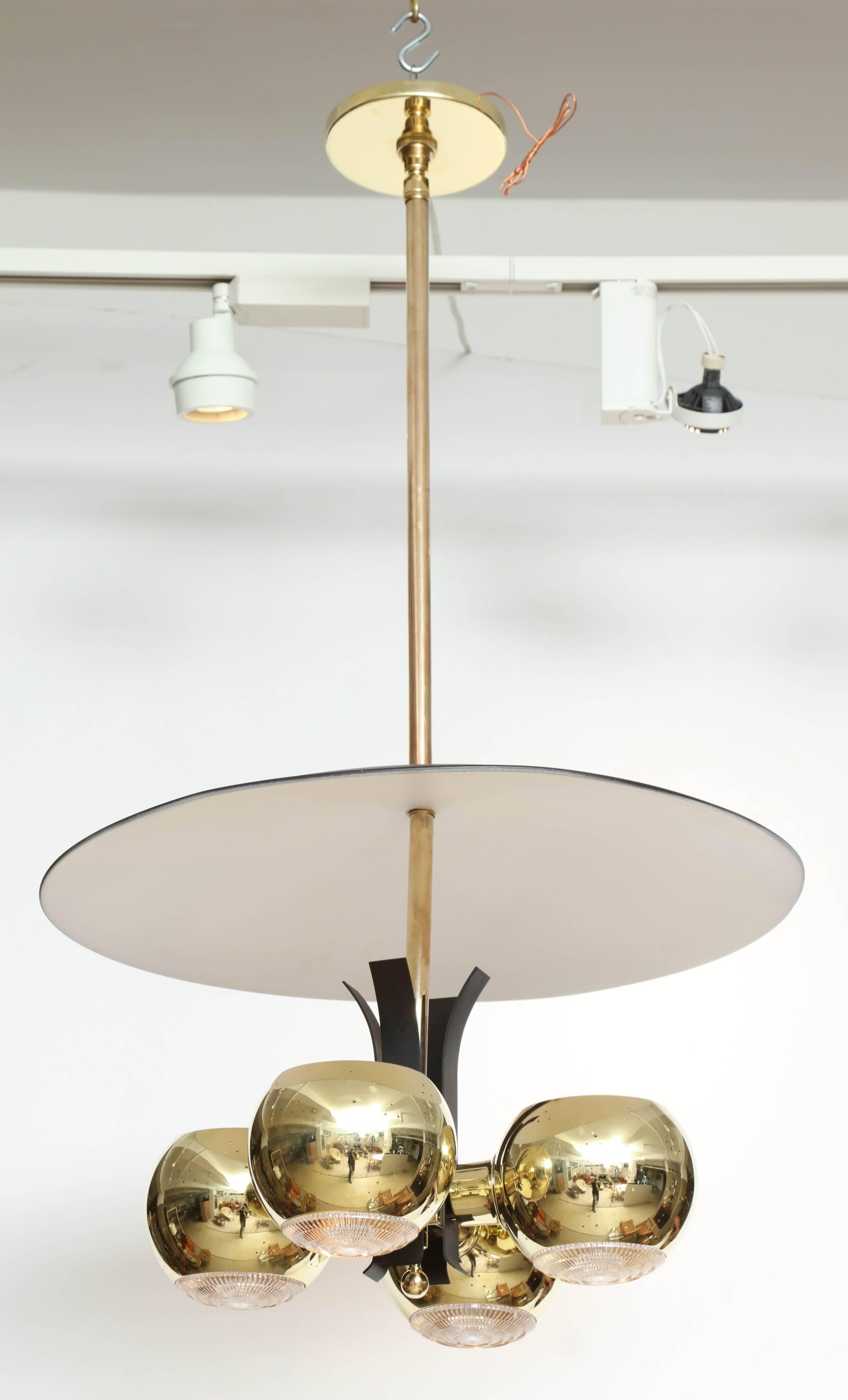 Four spheres of polished brass focus light upward to reflect from a white-painted shade and downwards through glass diffusers. The four lights create a four petaled flower pattern on the reflector when illuminated. By Stilnovo, Italy, 1950s. Newly