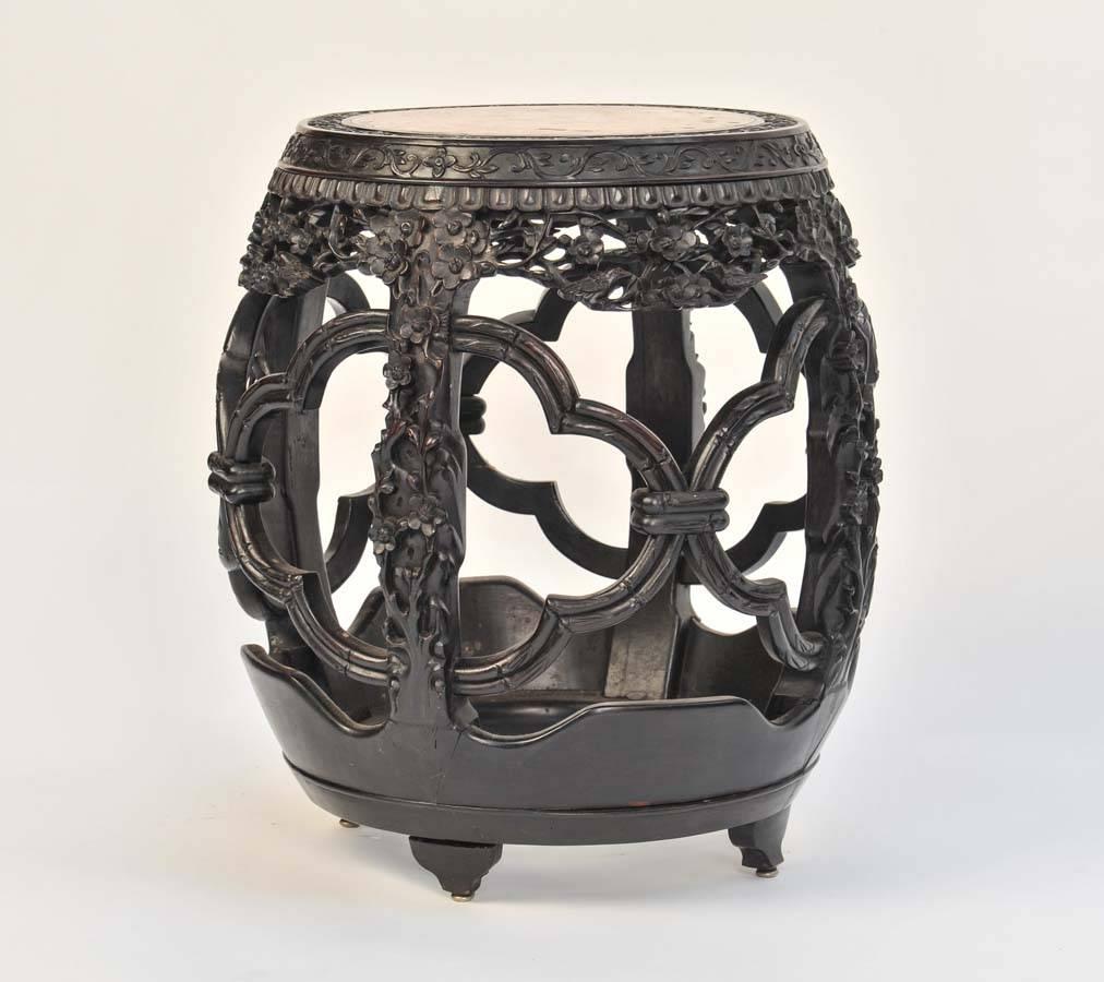 A very good quality 19th century carved Chinese hardwood barrel seat, having an inset marble seat and beautifully carved and fretted foliate decoration.