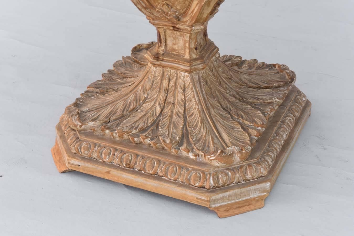 Center table, having a round top of marble, on carved wood, pedestal base, exaggerated urn form, outcarved with cartouche, on acanthine-carved foot, bordered by gadrooning.