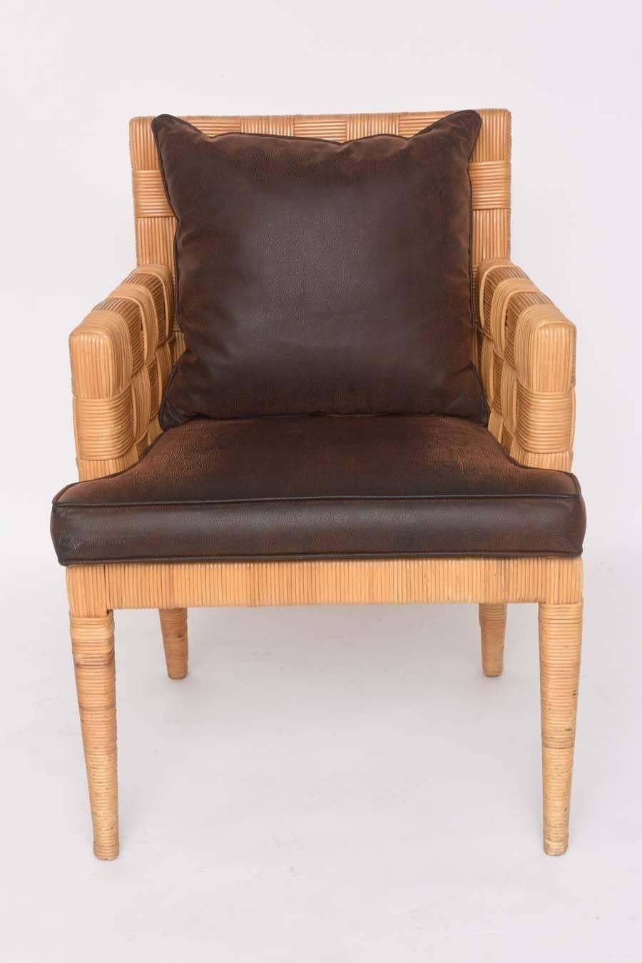 This pair of chairs by Angelo Donghia are from the "Block Island" collection and make for the perfect side chair or dining chair.

The upholstered cushion and pillow are in a textured faux-leather.

For best net trade price or