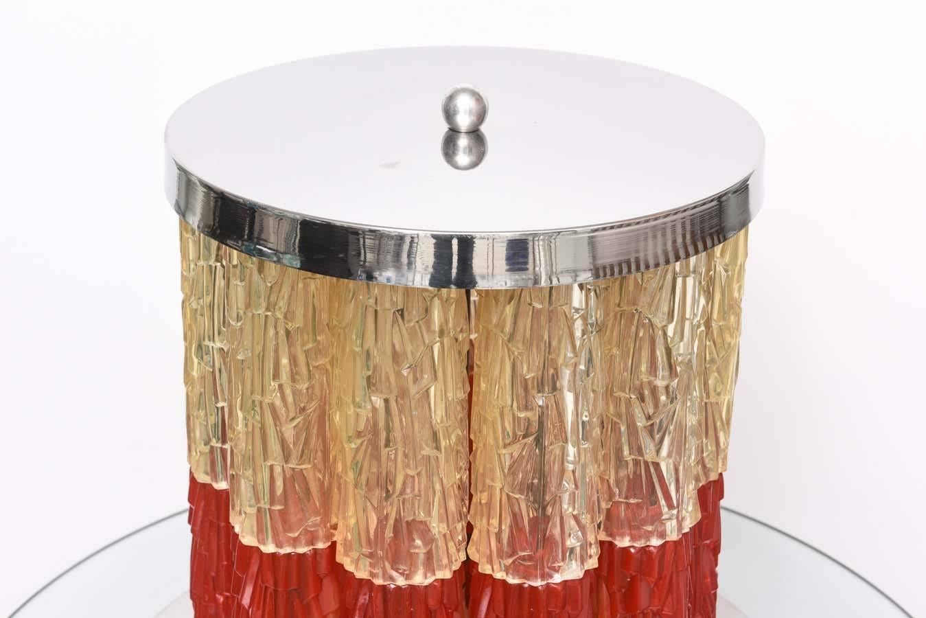This stylish Italian table lamp was created in the 1960s and is fabricated of Lucite tubes/prisms in an eisglas technique. The Lucite is in a muted red and yellowish color combination (see last photo).

For best net trade price or additional