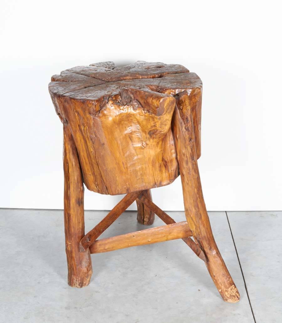 A highly unusual Chinese antique butcher block stool/table with a top that was hand carved  from a solid piece of elm wood that is 13 inches thick and about 18 inches wide.  A striking organically shaped  piece from rural China, this was used for