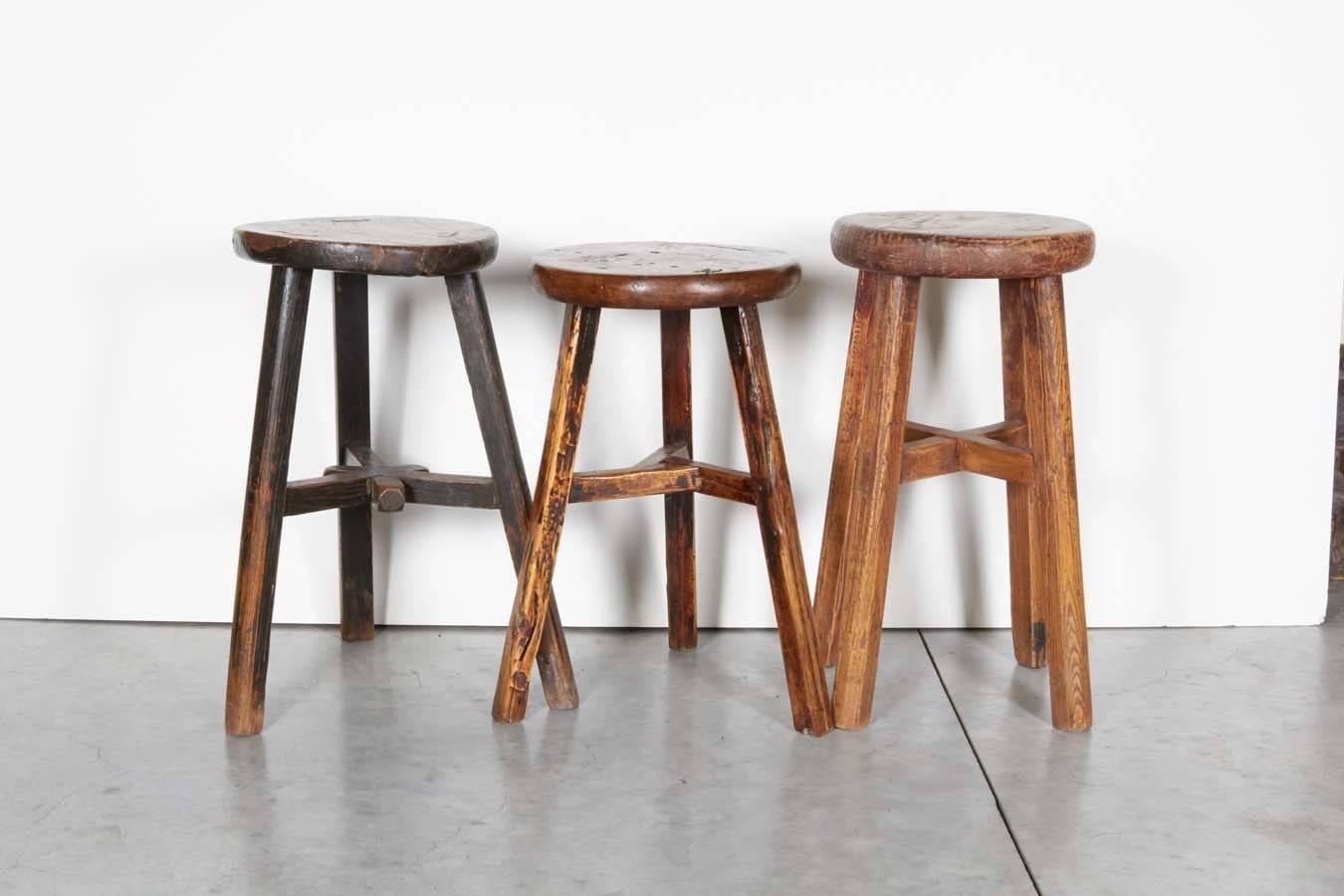 Three antique Chinese elm stools, each with a beautiful patina. Two with three legs and one with four legs. Classic pieces. Sold individually. From Shandong Province ,circa 1900.
2 pieces available, the two in foreground on main image, and image #5