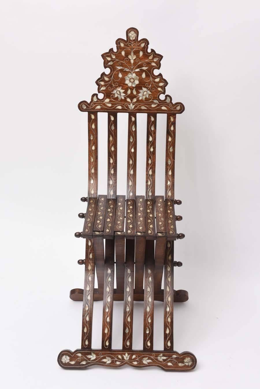 Syrian wood folding chair with intricate foliate inlays in silvered metal and mother-of-pearl. Excellent condition.