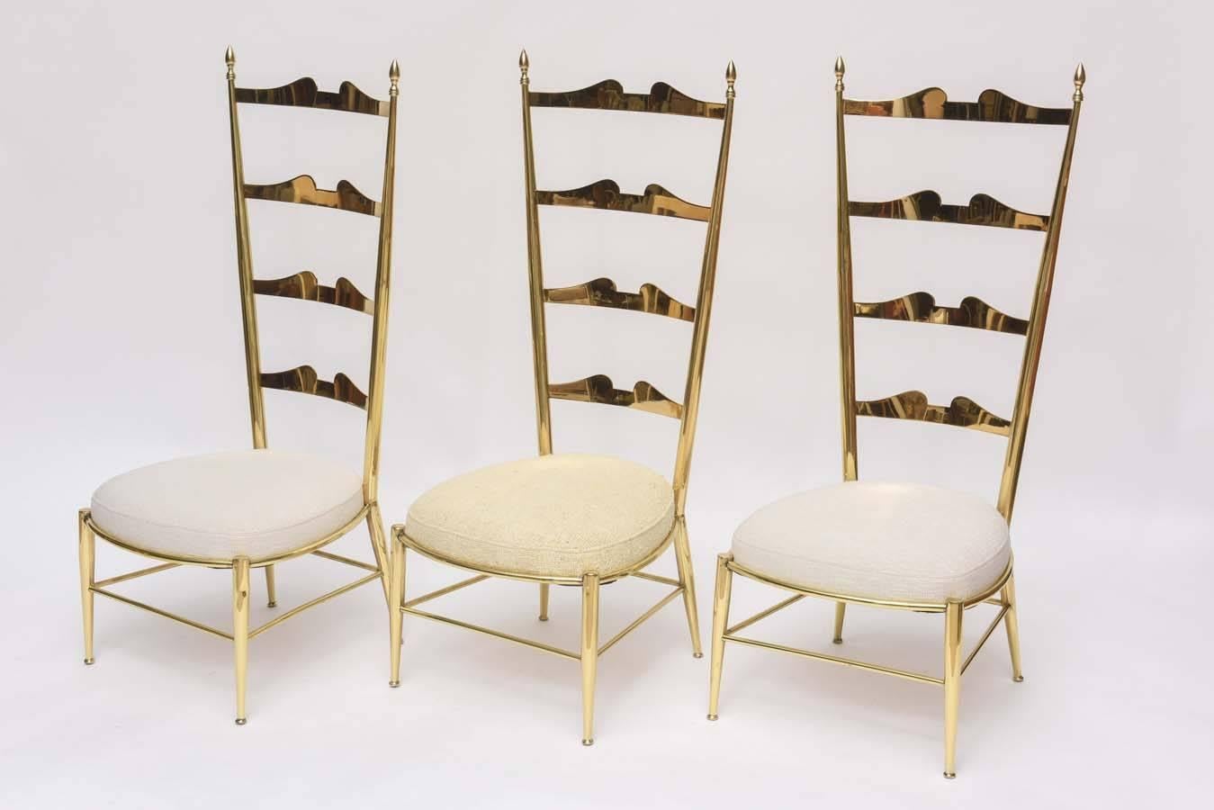 These fantastical and rare Italian brass Chiavari chairs have tall exaggerated backs and very low seats on truncated 9