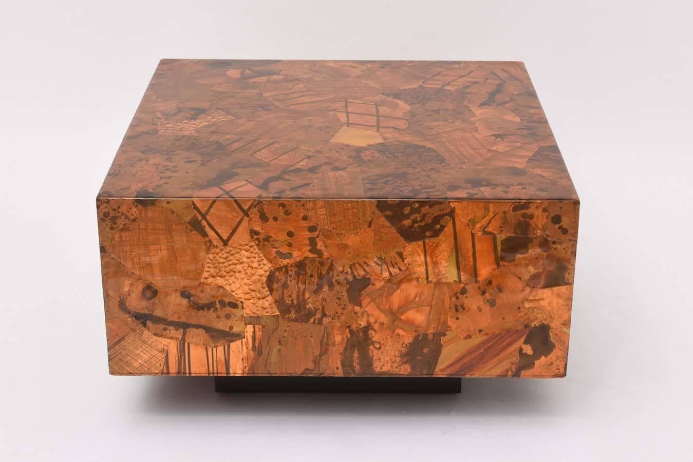 Brutalist copper patchwork table in the manner of Paul Evans. Black painted wood base with resin-coated copper. Nicely-scaled as either a smaller coffee table or larger end table.