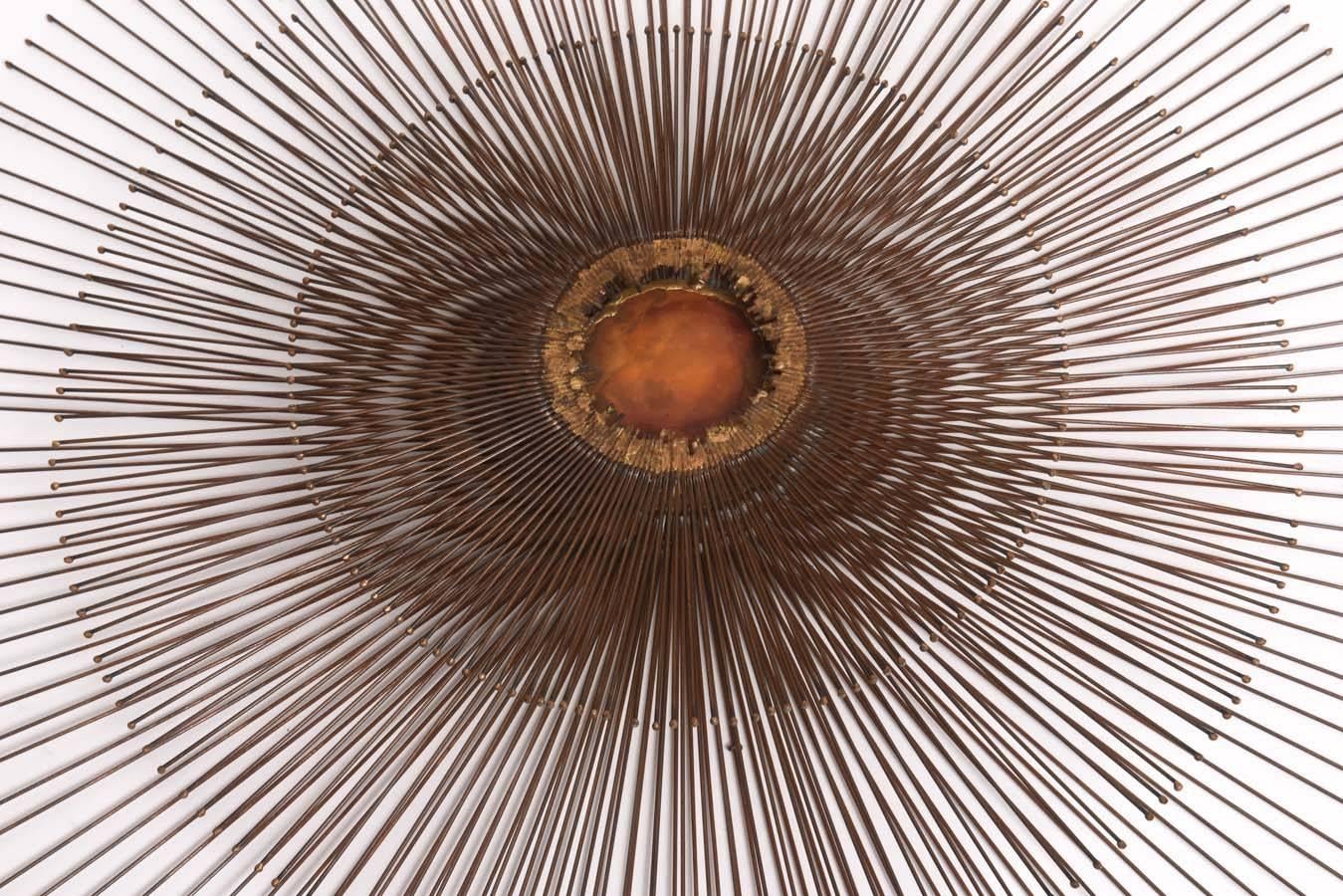 Impressively-scaled, beautifully crafted bronze triple layer sunburst wall sculpture with copper disc center and brass surround by William Friedle.