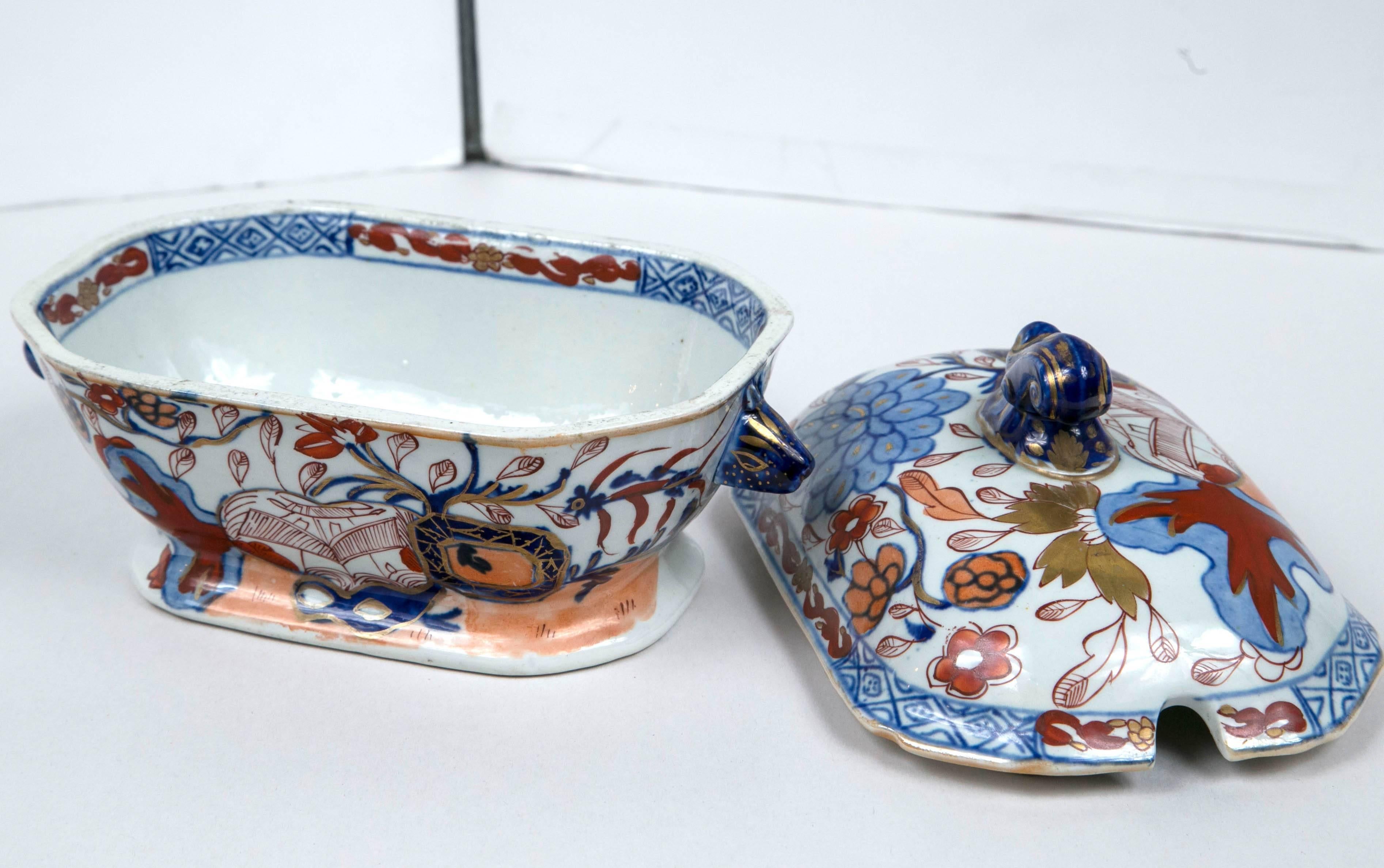 An English ironstone Imari-pattern tureen with lid. Hand-painted in rich blue and 
red or orange hues.