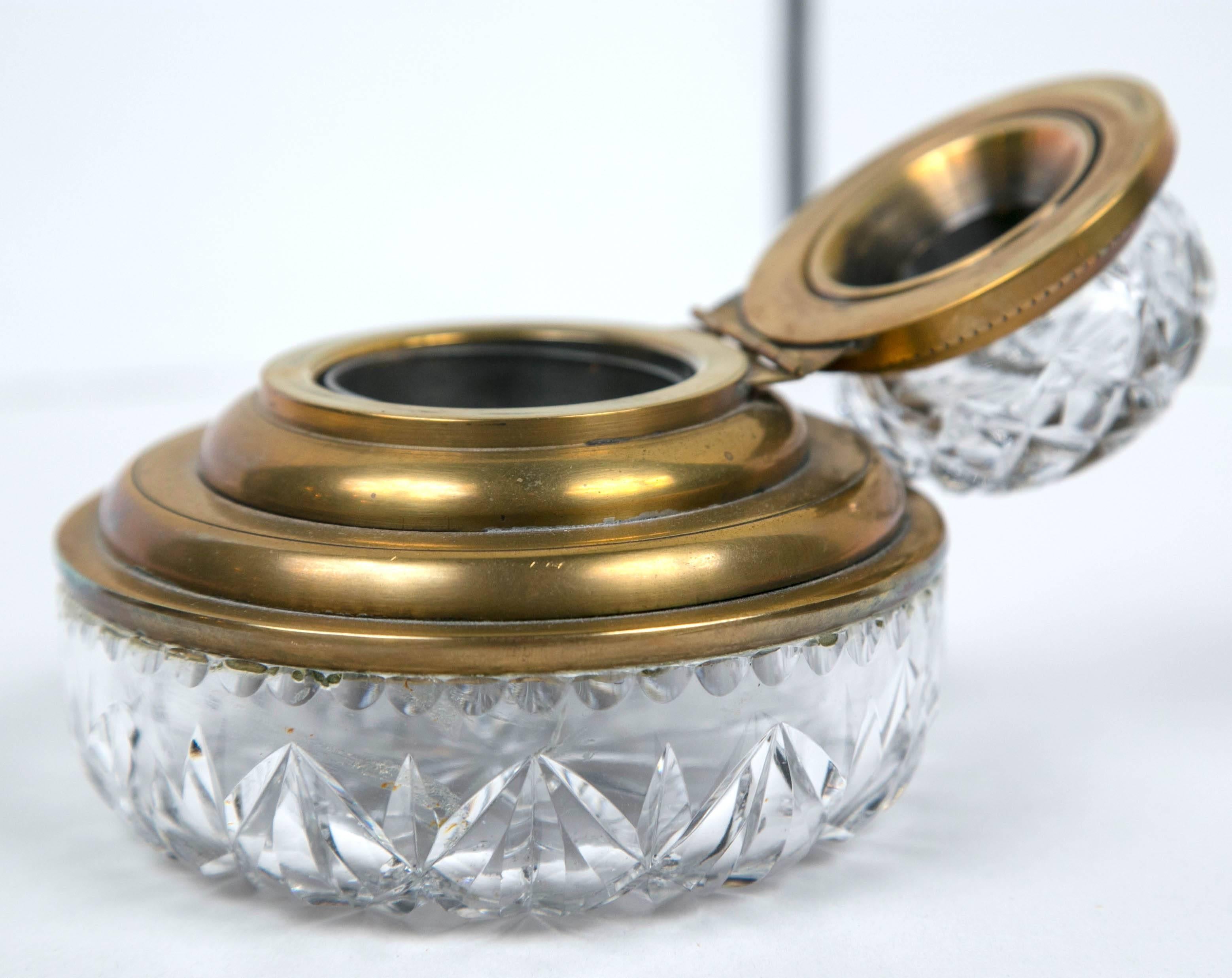 An antique cut crystal and bronze Edwardian inkwell. Bronze and crystal top attached by hinge.