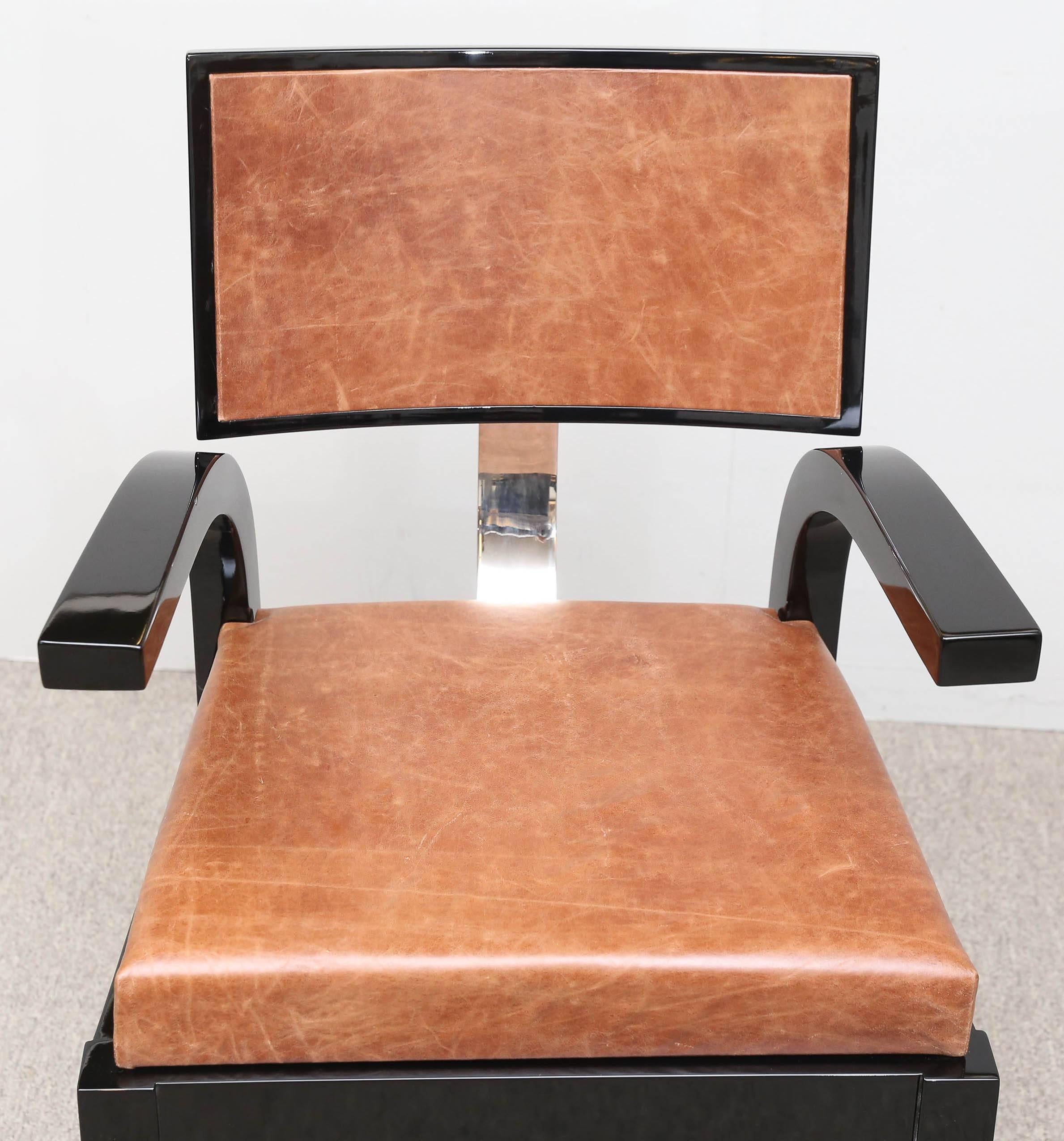 The frame is made out of ebonized wood. A sit and back are covered with cowhide. The back of the chair is attached to the sit with a chrome rectangular connector. 
In the fall of 1931, Lajos Kozma (1884-1848) presented the forerunner of the chair