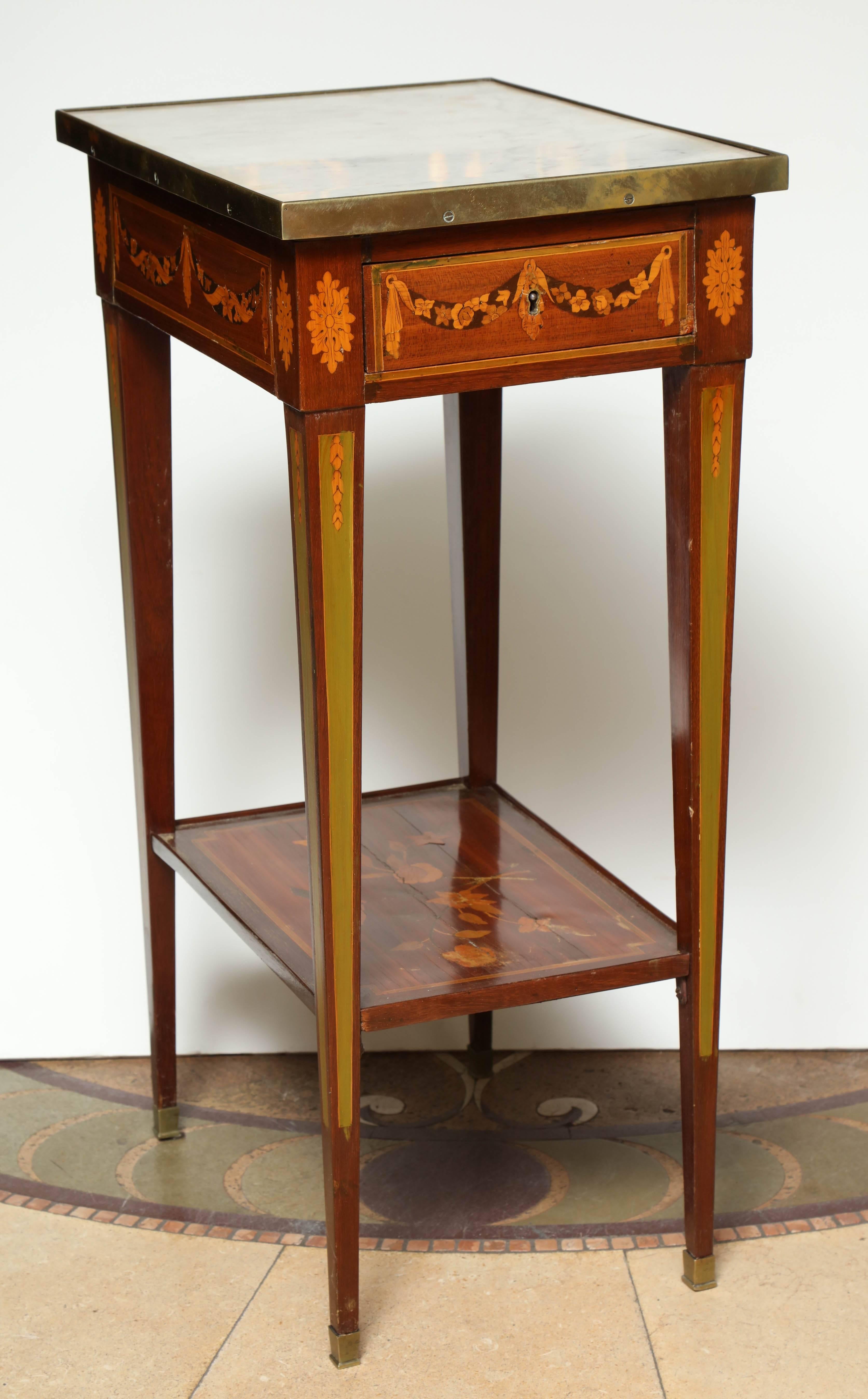 A fine Louis XVI marquetry inlaid side table with marble top, bronze banding, single drawer, shelf stretcher and square tapered legs.