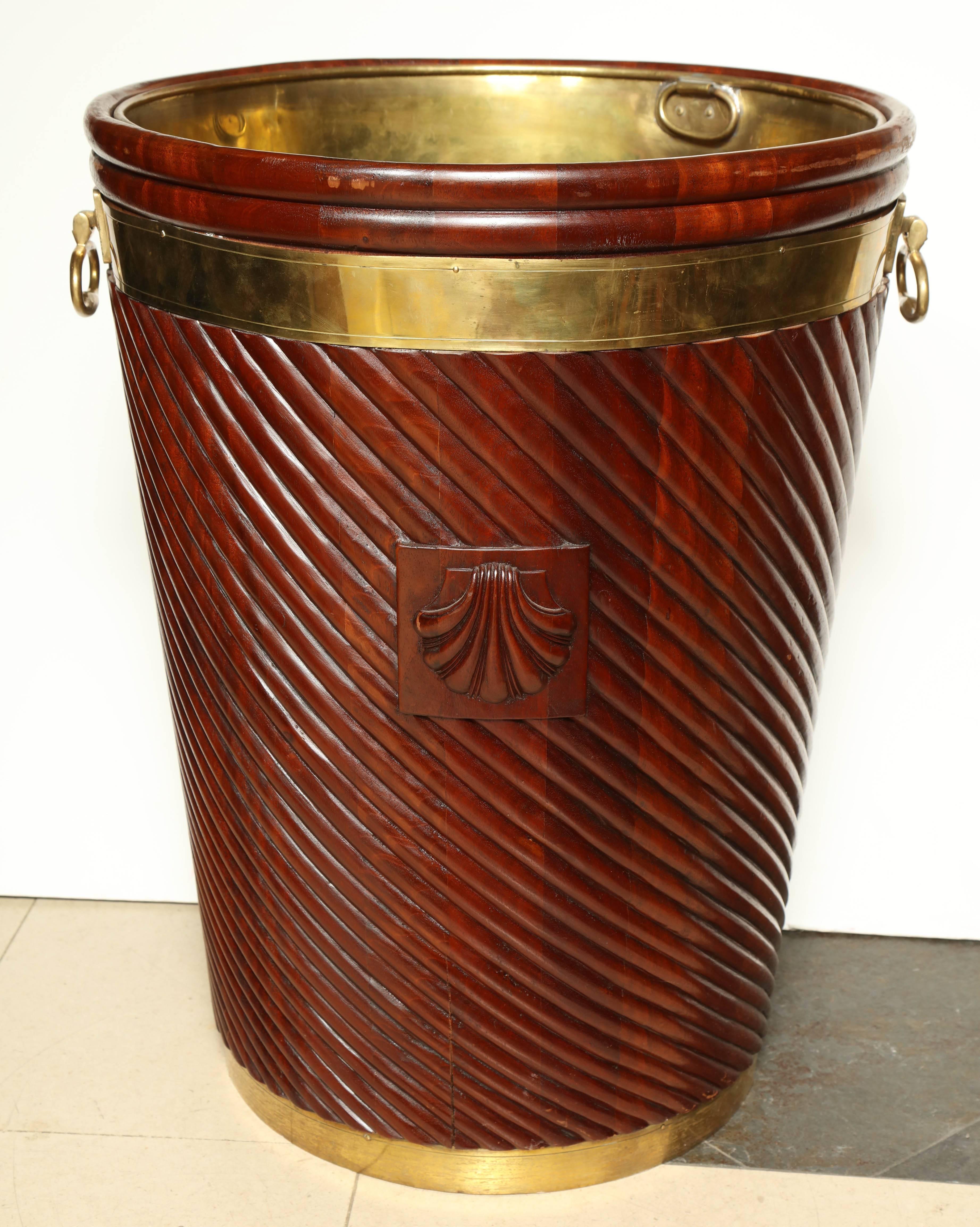 A large Irish George III carved diagonal reeded brass bound peat bucket with carved shells, removable brass liner and handles.