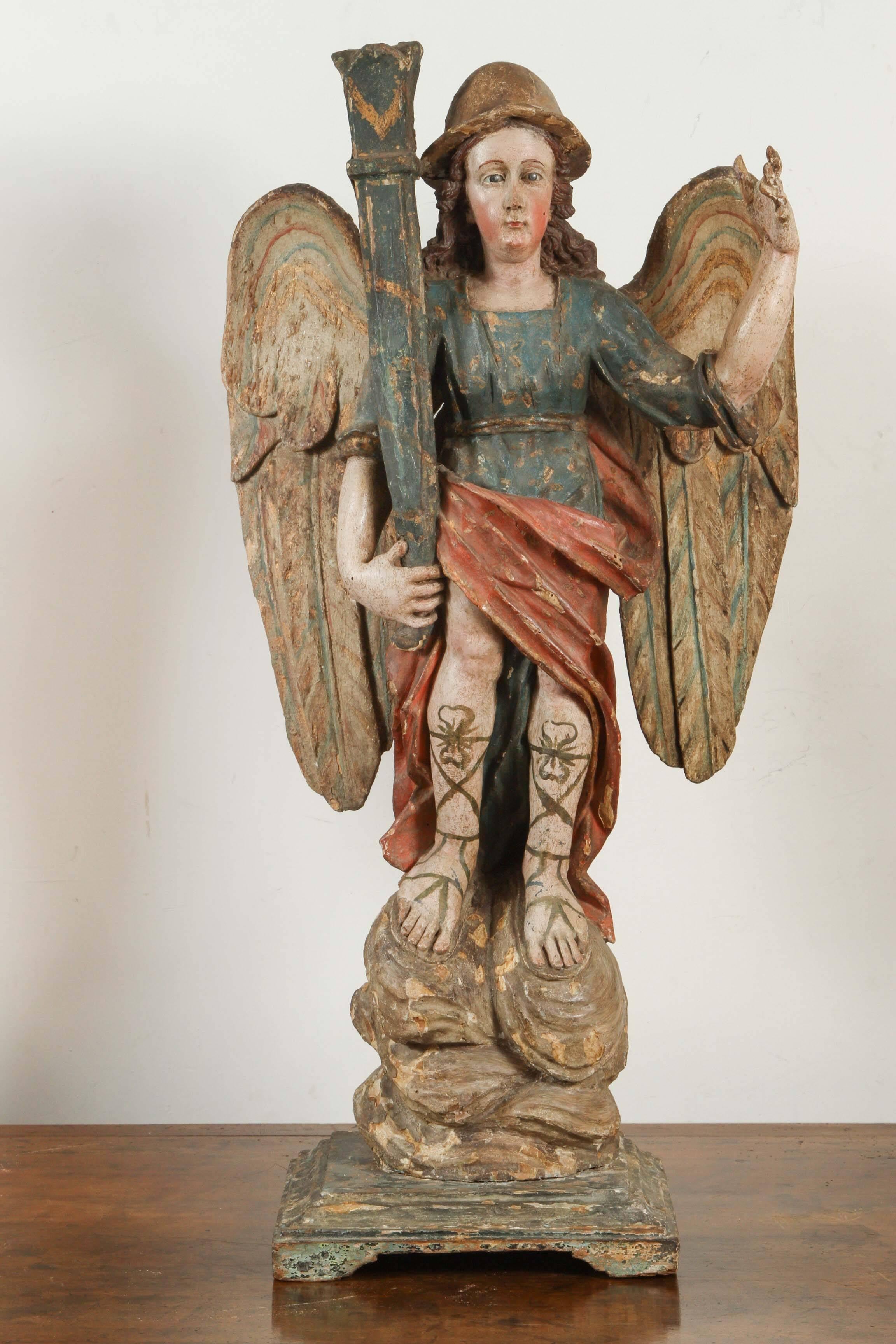 Pair of exceptional, Continental left and right, hand-carved wood,  polychrome angel candlesticks featuring glass eyes, pith helmets and multi-colored wings.